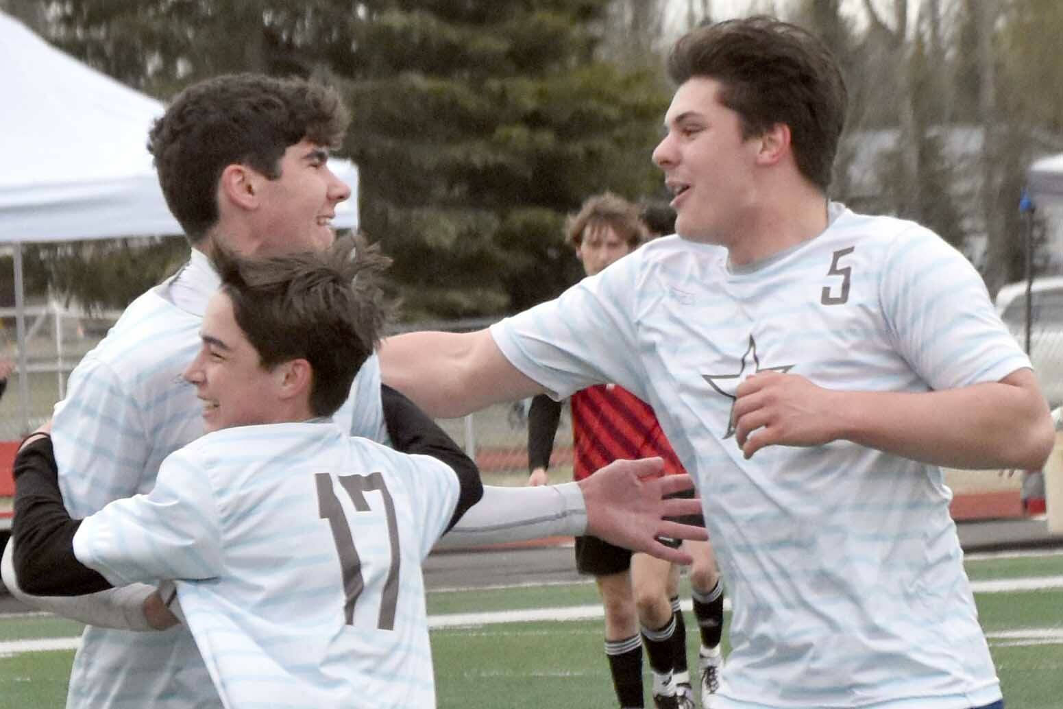 Soldotna's Andrew Arthur celebrates his goal with Lane Hillyer (17) and Gehret Medcoff (5) on Saturday, May 18, 2024, at the Peninsula Conference tournament at Kenai Central High School in Kenai, Alaska. (Photo by Jeff Helminiak/Peninsula Clarion)