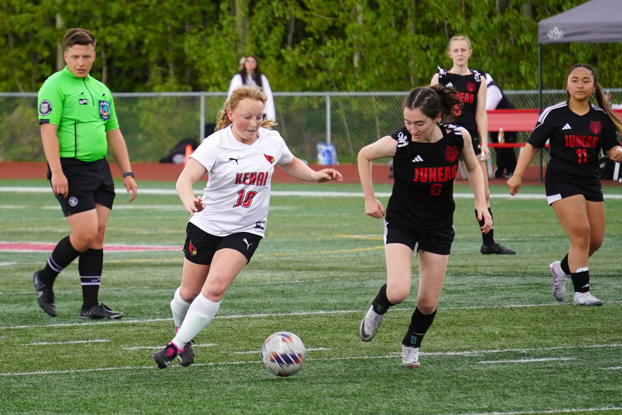 Kenai’s Kylee Verkuilen battles Juneau-Douglas’ Cerys Hudson for the ball during the ASAA Soccer Division II State Championships at Veterans Memorial Field in Wasilla, Alaska, on Saturday, May 25, 2024. (Jake Dye/Peninsula Clarion)