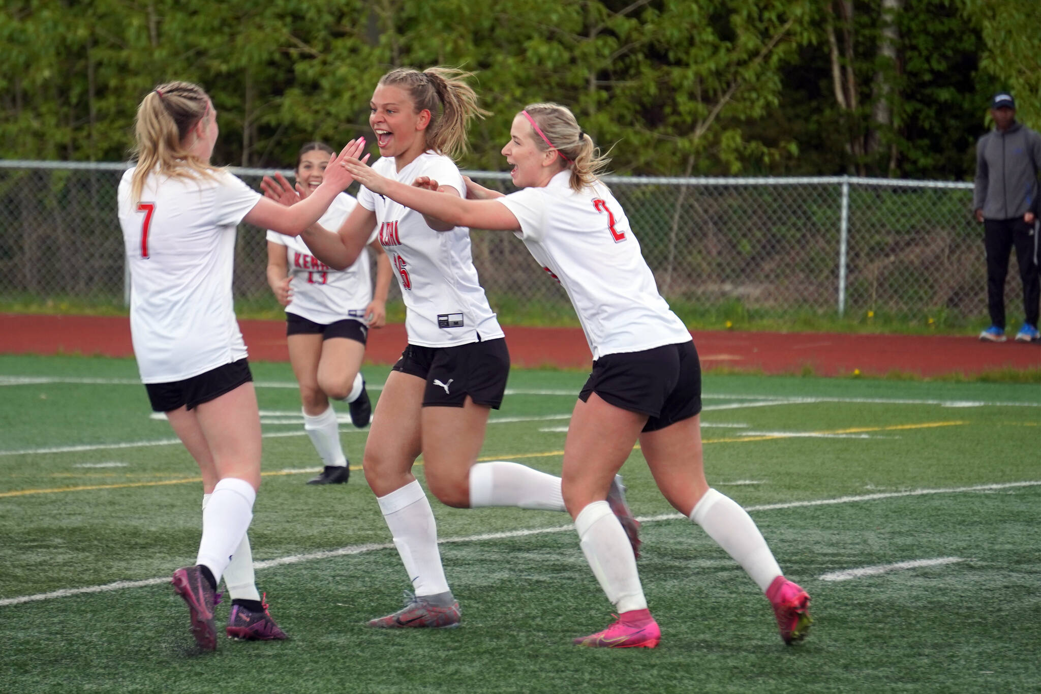 The Kenai Central High School girls celebrate after a goal by Katie Johnson during the ASAA Soccer Division II State Championships at Veterans Memorial Field in Wasilla, Alaska, on Saturday, May 25, 2024. (Jake Dye/Peninsula Clarion)