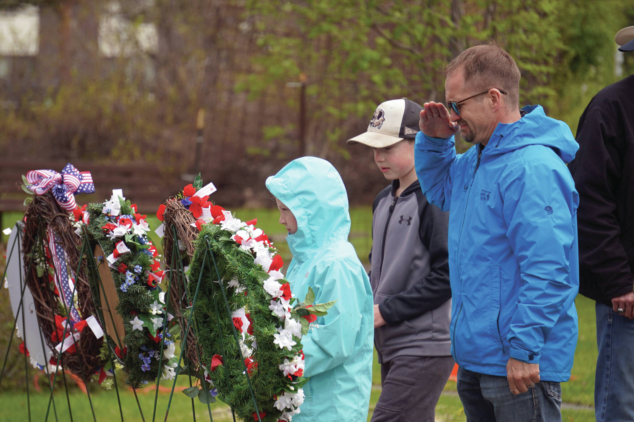 Poppies are affixed to wreaths during a Memorial Day ceremony at Leif Hanson Memorial Park in Kenai on Monday. (Jake Dye/Peninsula Clarion)