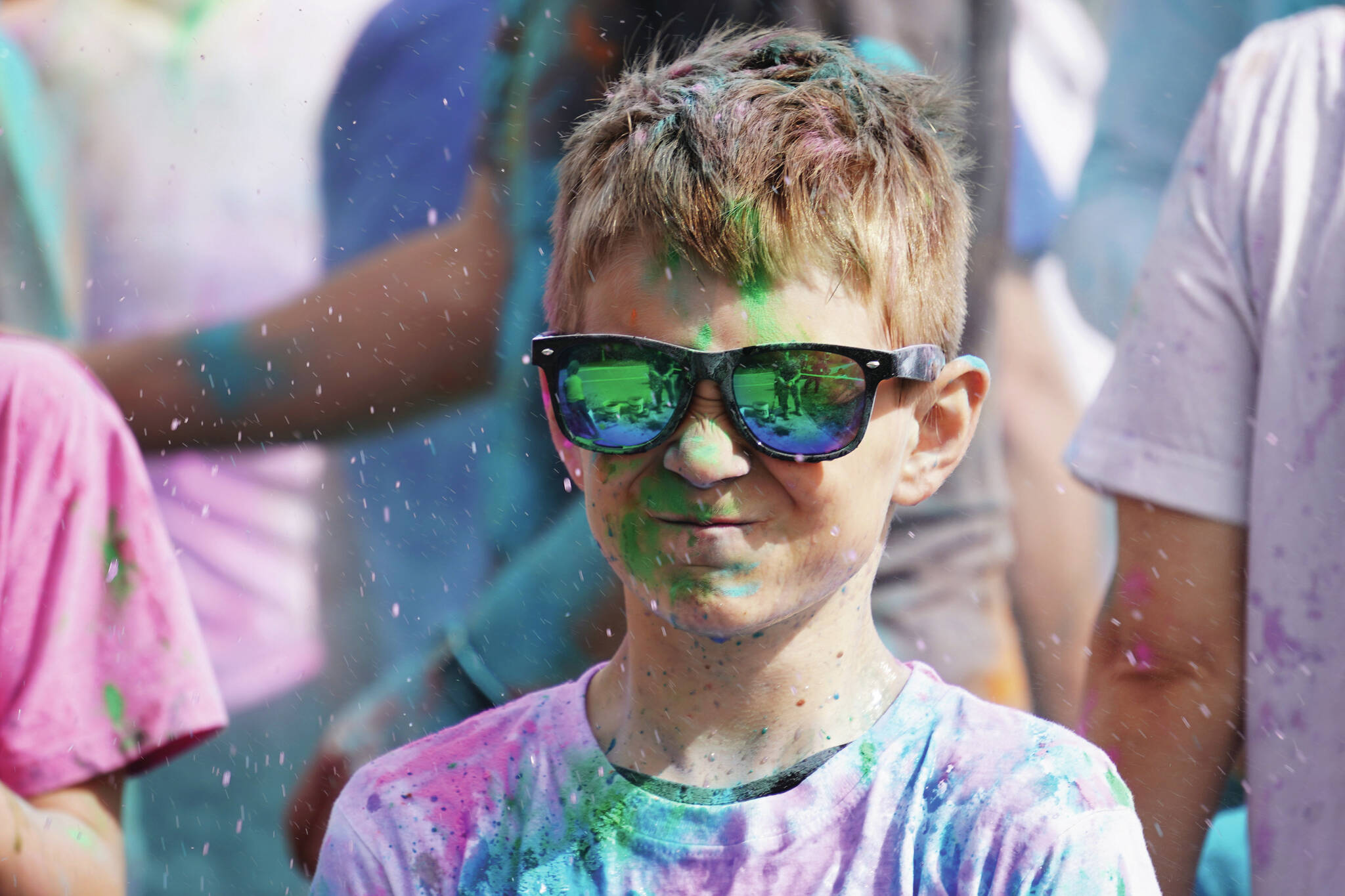 Participants are covered with colored powder during a color run held as part of during the Levitt AMP Soldotna Music Series on Wednesday, June 7, 2023, at the Kenai National Wildlife Refuge Visitor’s Center in Soldotna (Jake Dye/Peninsula Clarion)