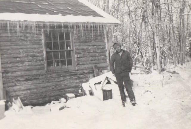 Ira Little poses outside of his recently completed Soldotna homestead cabin in 1947. (Little Family photo courtesy of the Soldotna Historical Society)