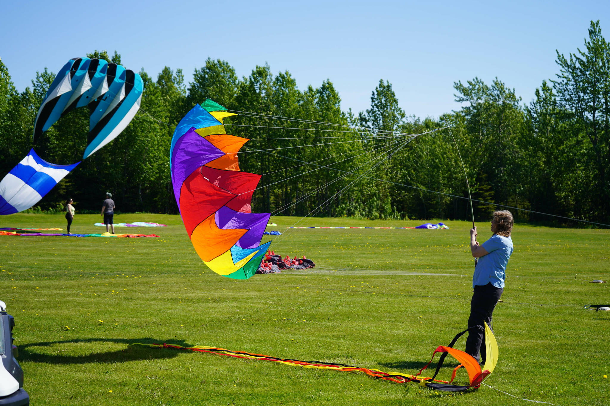 Kites flown by Alaskiters rise into the sky above Millennium Square in Kenai, Alaska, during the Kenai Kite Festival on Saturday, June 15, 2024. (Jake Dye/Peninsula Clarion)
