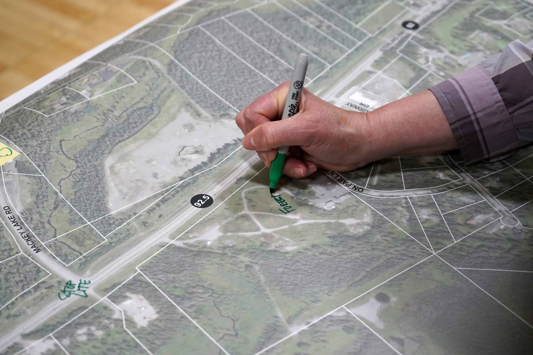 Attendees write their feedback for the Sterling Safety Corridor Improvements project during a town hall event at the Sterling Community Center in Sterling, Alaska, on Tuesday, June 25, 2024. (Jake Dye/Peninsula Clarion)