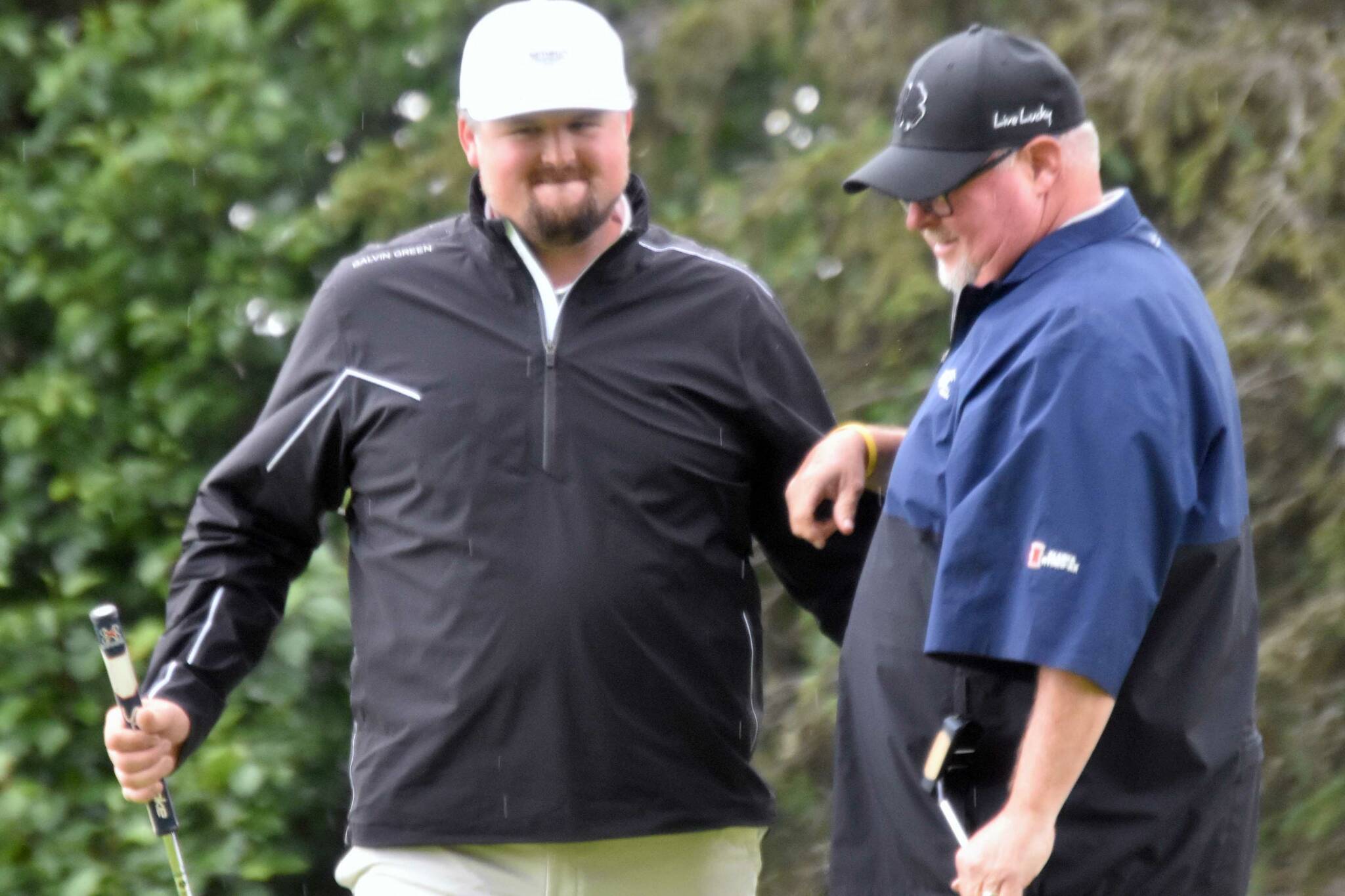 Beau Forrest congratulates George Collum after Collum rolled in a putt on No. 4 for a skin at the State Farm Agent Heith Groth Pro Am and Skins Game on Monday, July 15, 2024, at Birch Ridge Golf Course in Soldotna, Alaska. (Photo by Jeff Helminiak/Peninsula Clarion)