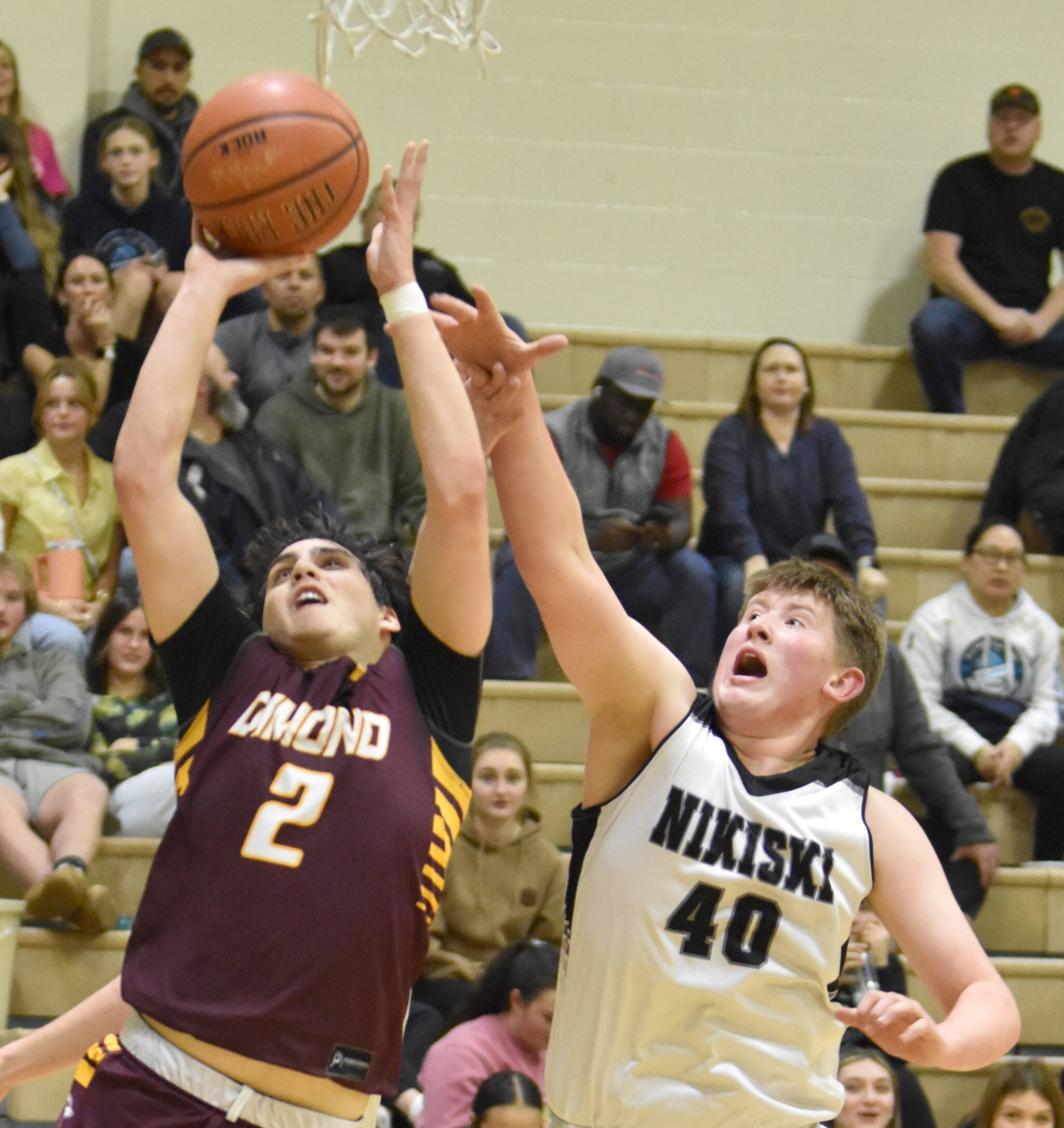 Dimond’s Jace Christophersen drives on Nikiski’s Kameron Bird at the 36th Annual Rus Hitchcock Nikiski Tip Off Tournament on Thursday, Jan. 16, 2025, at Nikiski Middle-High School in Nikiski, Alaska. (Photo by Jeff Helminiak/Peninsula Clarion)