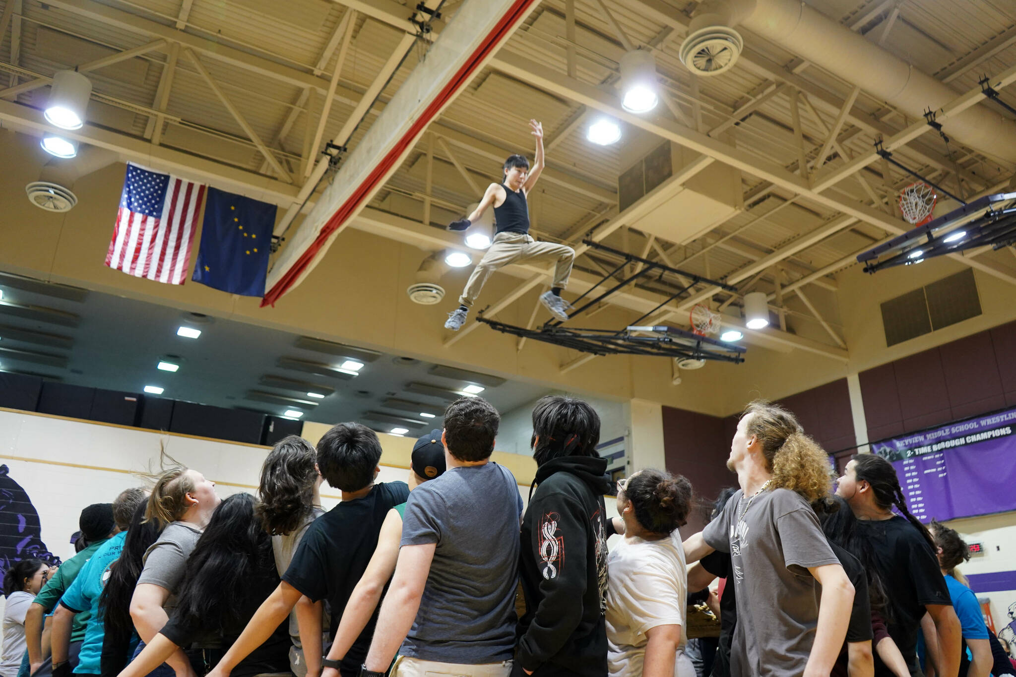 More than 50 people work together to perform a traditional blanket toss during the Kahtnuht’ana Hey Chi’ula Native Youth Olympics Invitational at Skyview Middle School near Soldotna, Alaska, on Sunday, Jan. 26, 2025. (Jake Dye/Peninsula Clarion)