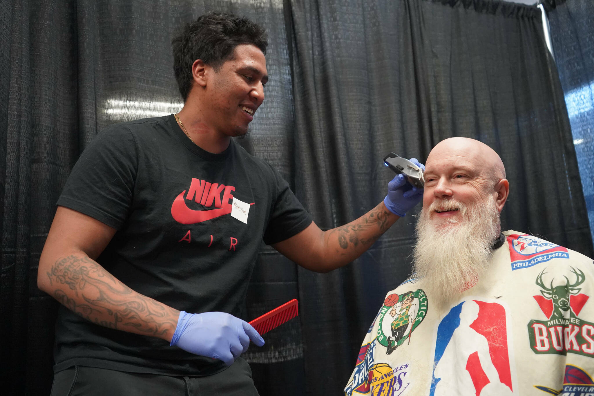 Mersha Tamrat gives free haircuts during the 14th Annual Project Homeless Connect at the Soldotna Regional Sports Complex in Soldotna, Alaska, on Tuesday, Jan. 28, 2025. (Jake Dye/Peninsula Clarion)