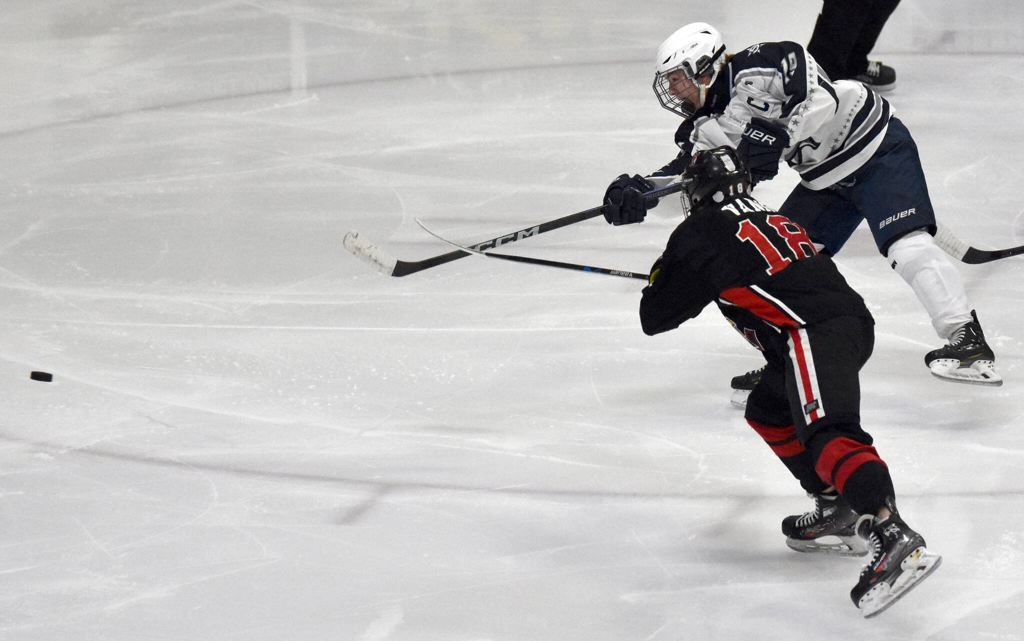Soldotna’s Marshall DeRaeve fires past Kenai Central’s Sawyer Vann for a goal Thursday, Jan. 30, 2025, at the Soldotna Regional Sports Complex in Soldotna, Alaska. (Photo by Jeff Helminiak/Peninsula Clarion)