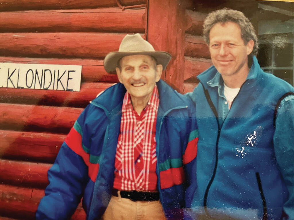 Bob Kanegis (right) poses with Clarence Hiram “Poopdeck” Platt in front of Platt’s cabin near the center of Homer, circa late 1990s. (Photo courtesy of Bob Kanegis)