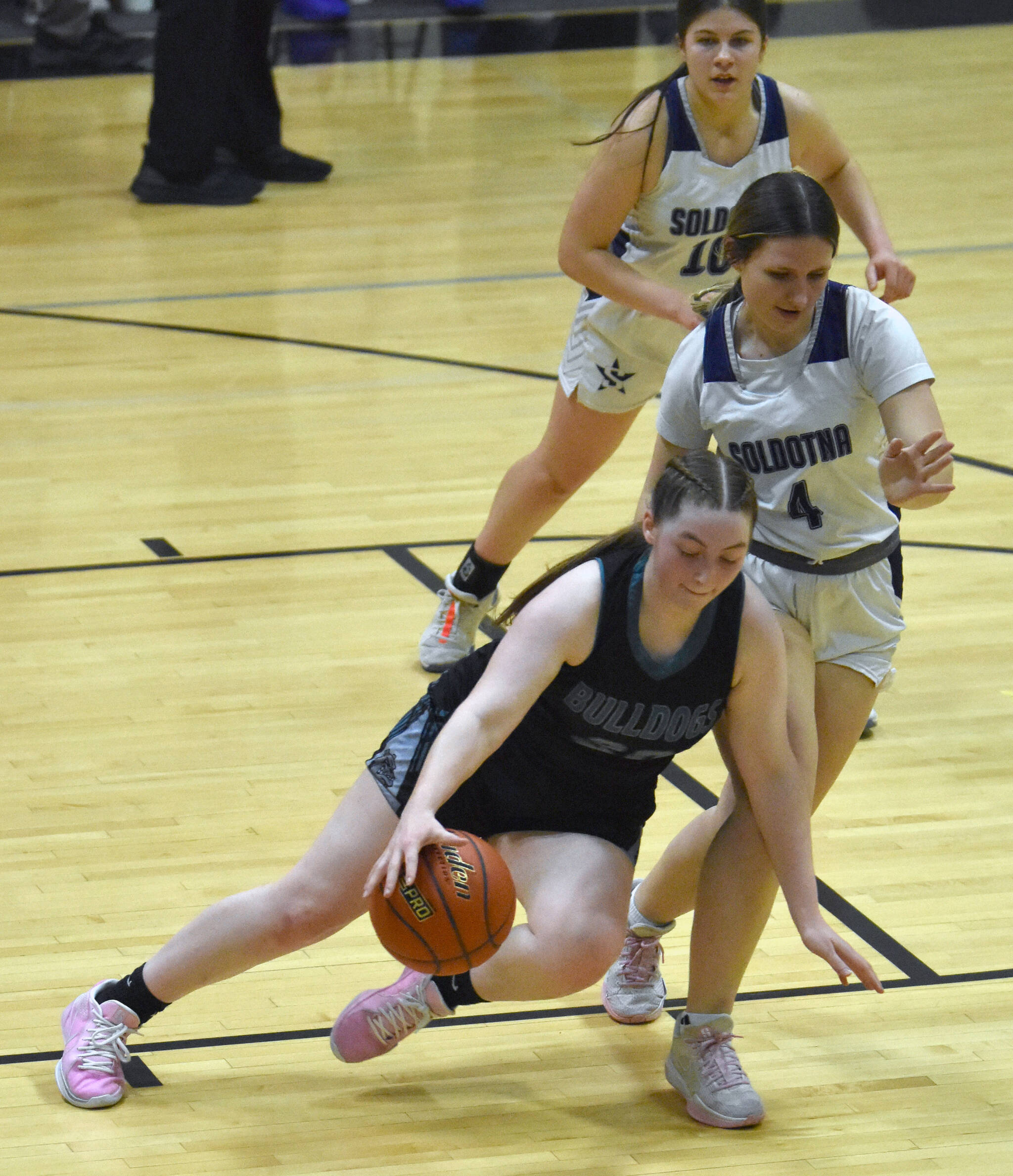 Nikiski’s Avery Ellis brings the ball up against Soldotna’s Anika Jedlicka on Tuesday, February 5, 2025, at Nikiski Middle-High School in Nikiski, Alaska. (Photo by Jeff Helminiak/Peninsula Clarion)