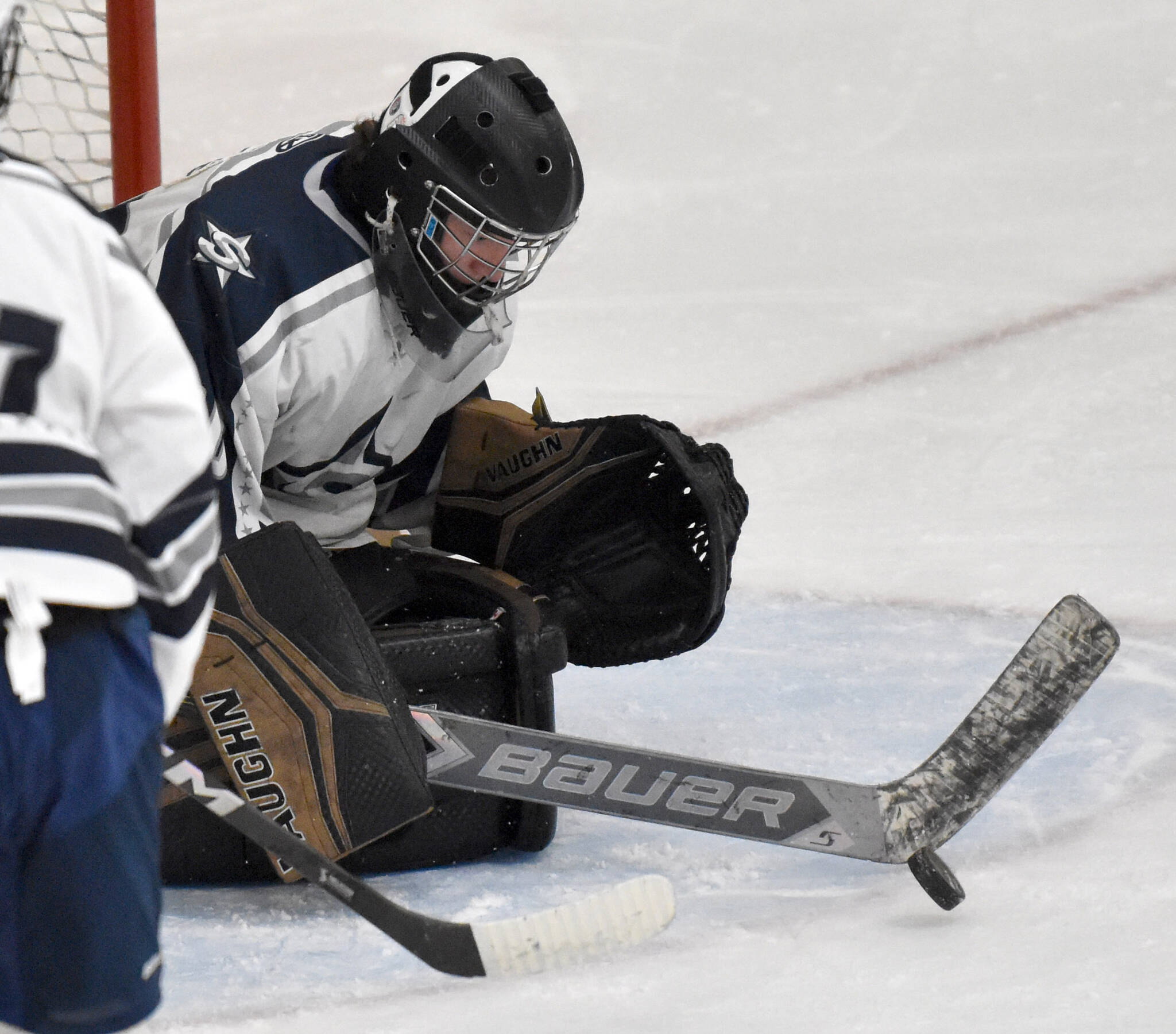 Soldotna goalie Brycen Clyde makes a save against Delta at the First National Cup Division II state hockey tournament at the Soldotna Regional Sports Complex in Soldotna, Alaska, on Thursday, February 6, 2025. (Photo by Jeff Helminiak/Peninsula Clarion)