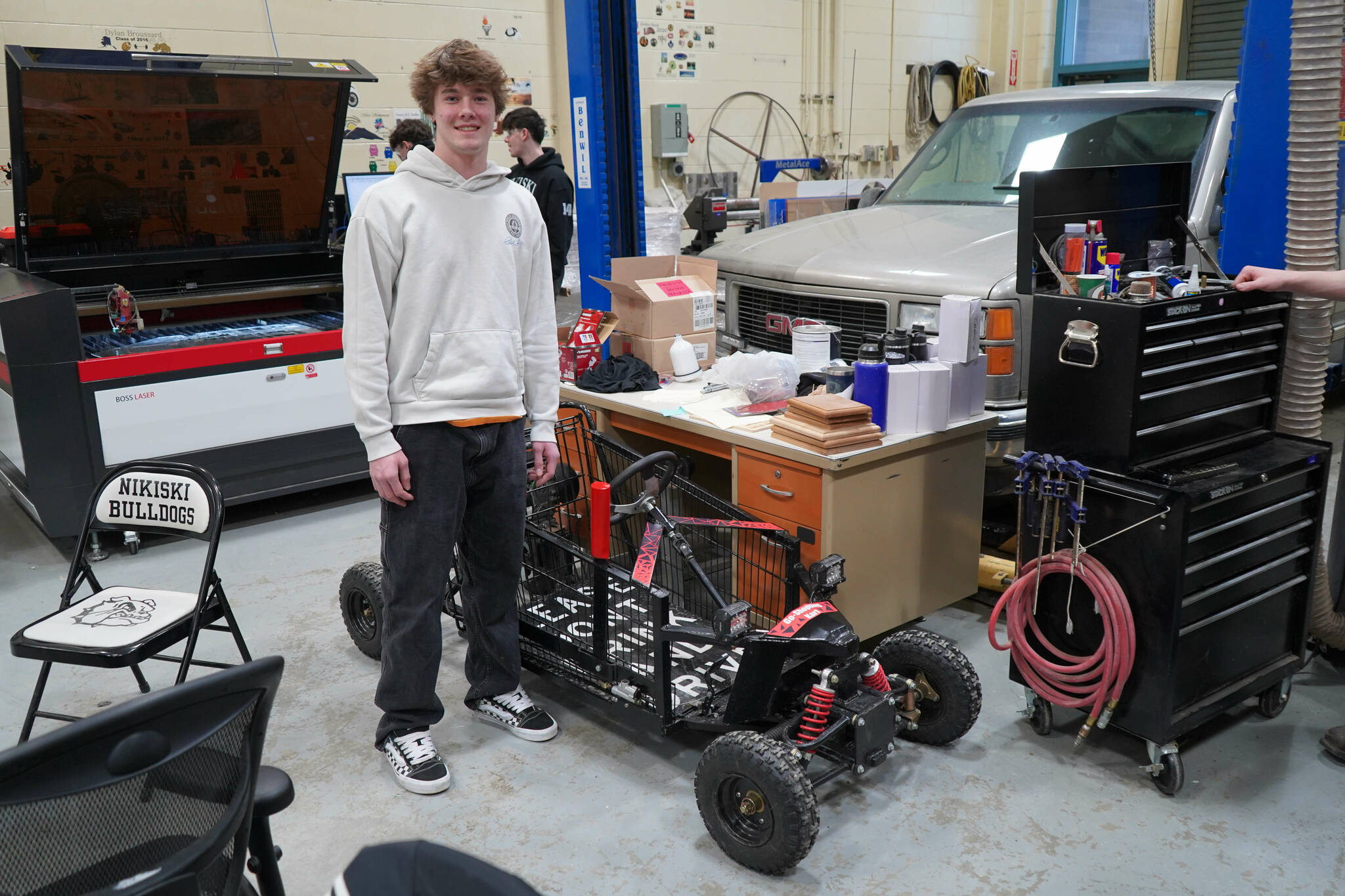 Gavin Ley stands with the “Go-Shopping Kart” he designed and built in his career and technical education courses at Nikiski Middle/High School in Nikiski, Alaska, on Tuesday, Feb. 11, 2025. (Jake Dye/Peninsula Clarion)