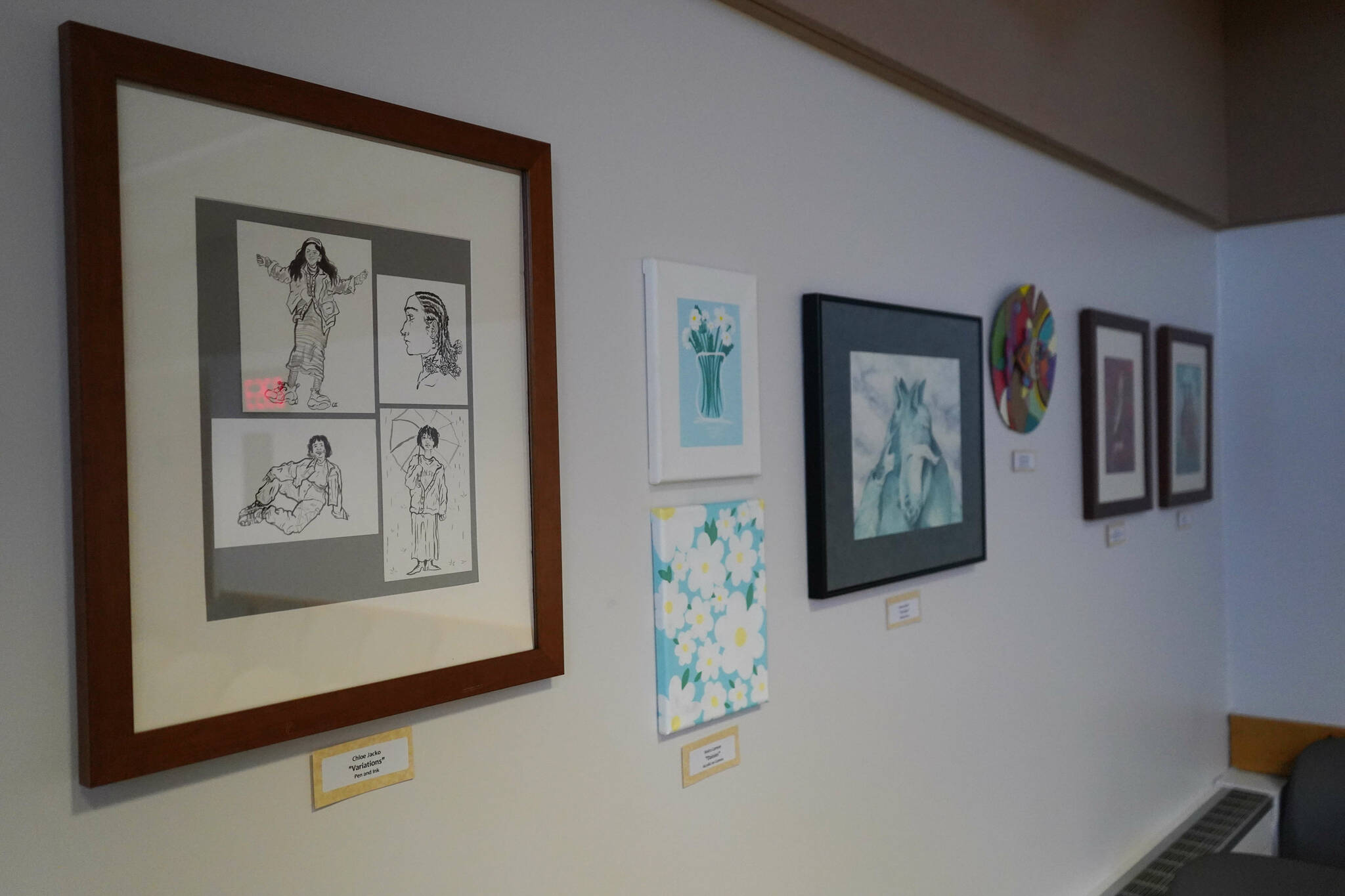 Artwork by Chloe Jacko and other Soldotna High School students is seen as part of the inaugural exhibition of “Spirit of Soldotna: Showcasing Student Art” in Soldotna City Hall in Soldotna, Alaska, on Wednesday, Feb. 12, 2025. (Jake Dye/Peninsula Clarion)