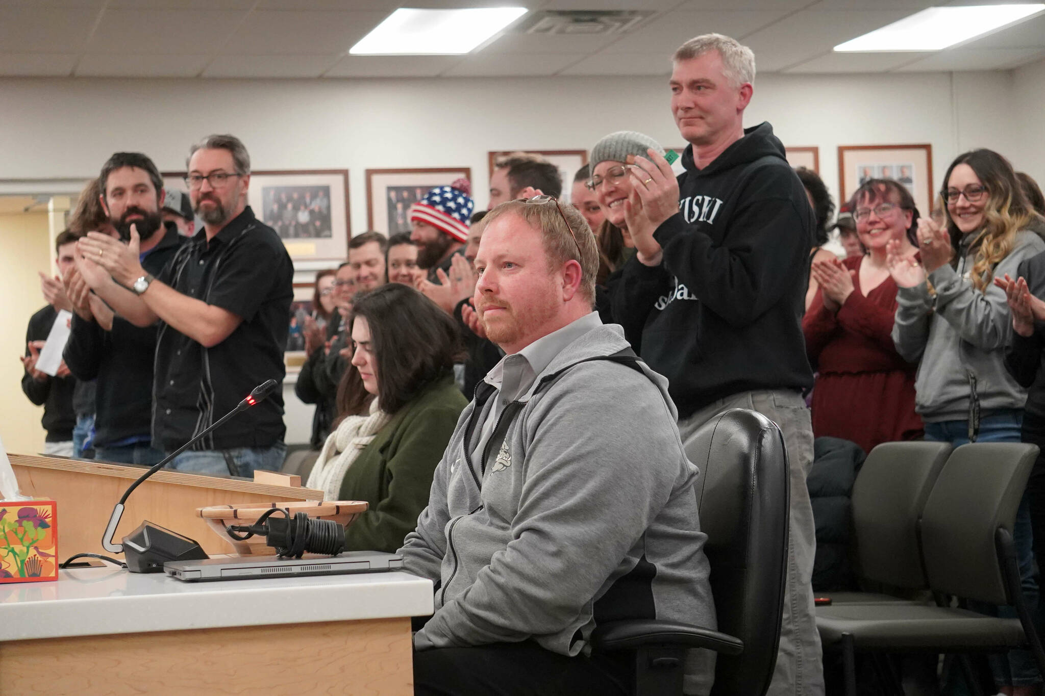 Nikiski teachers, students and parents applaud Nikiski Middle/High Principal Mike Crain as he’s recognized as the Alaska Association of Secondary School Principals 2025 Region III Principal of the Year by the Kenai Peninsula Borough School District’s Board of Education during their meeting in Soldotna, Alaska, on Monday, Feb. 3, 2025. (Jake Dye/Peninsula Clarion)