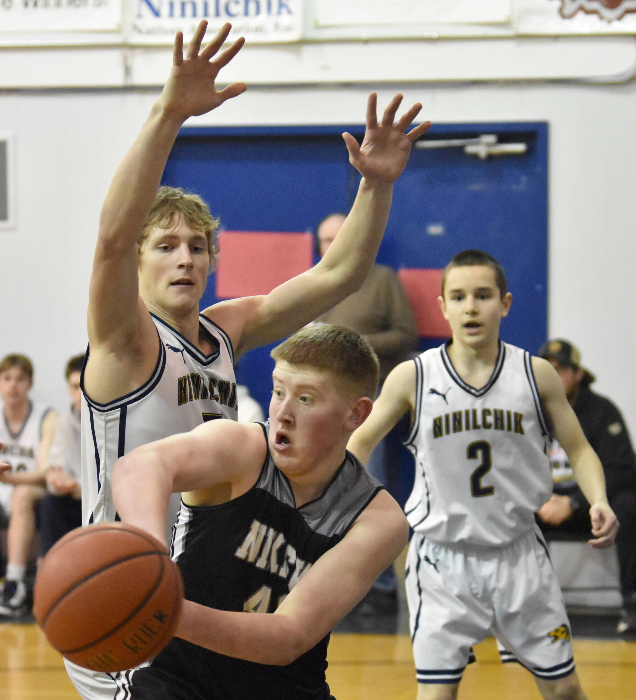 Nikiski’s Kameron Bird is pressured by Ninilchik’s Kade McCorison at the Keith Presley Memorial Tournament on Friday, February 14, 2025, at Ninilchik School in Ninilchik, Alaska. (Photo by Jeff Helminiak/Peninsula Clarion)