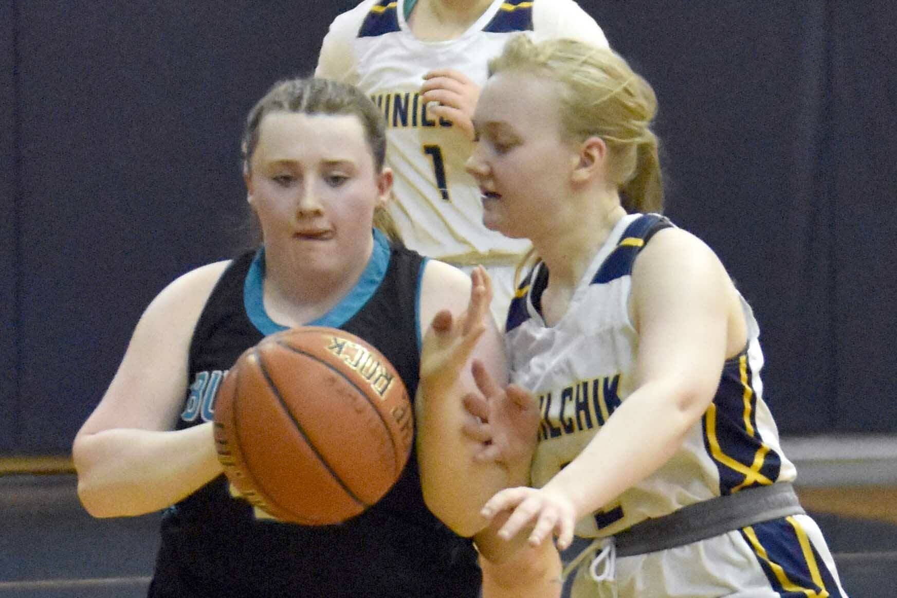 Kylie Northington of Nikiski JV brings the ball up against Ninilchik's Audry Herndon at the Keith Presley Memorial Tournament on Friday, February 14, 2025, at Ninilchik School in Ninilchik, Alaska. (Photo by Jeff Helminiak/Peninsula Clarion)