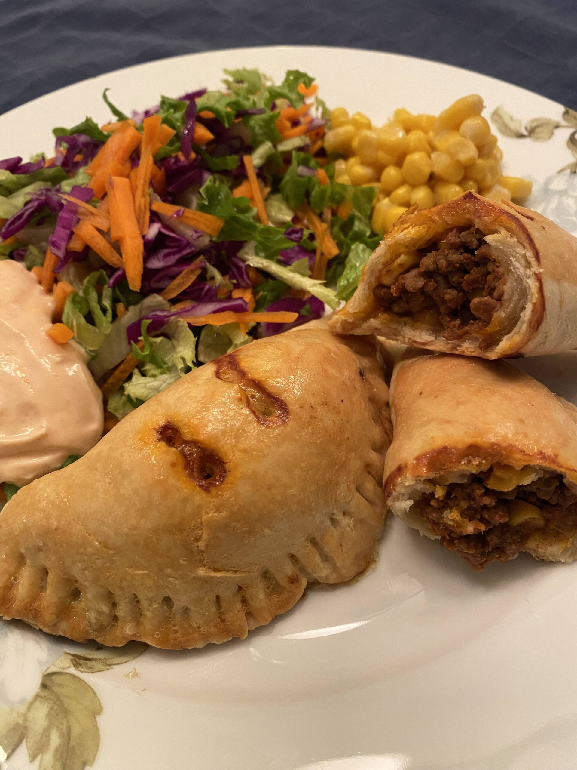 Beef empanadas are served with mixed greens and corn. (Photo by Tressa Dale/Peninsula Clarion)