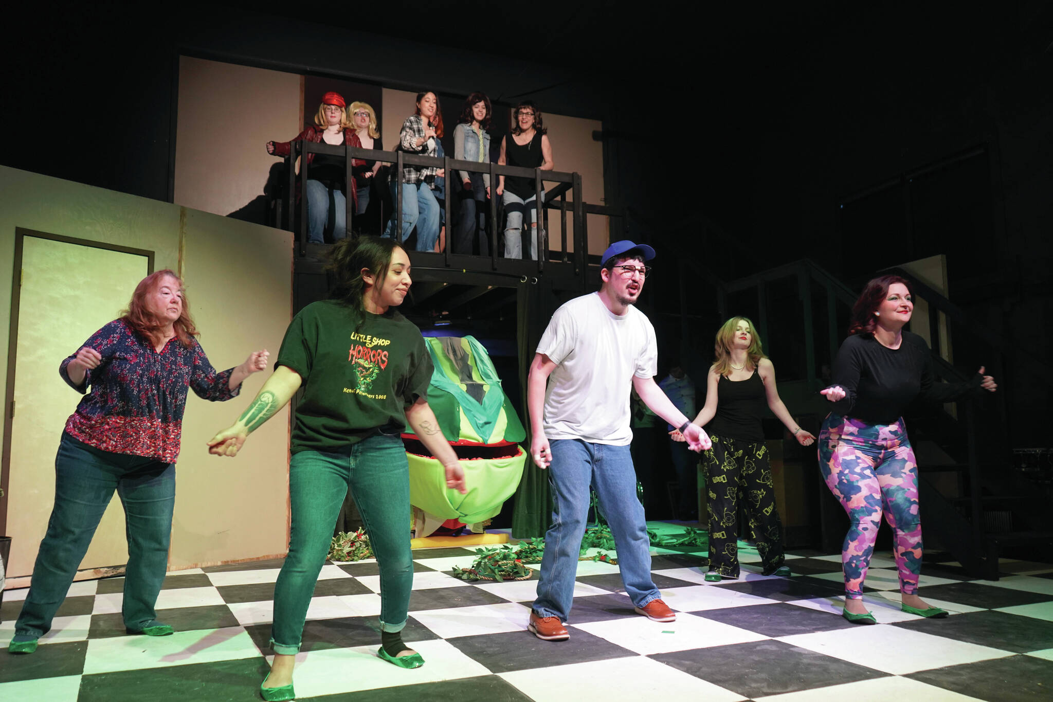 The cast of the Kenai Performers’ “Little Shop of Horrors” rehearse at the Kenai Performers Theater near Soldotna on Saturday, Feb. 15. (Jake Dye/Peninsula Clarion)