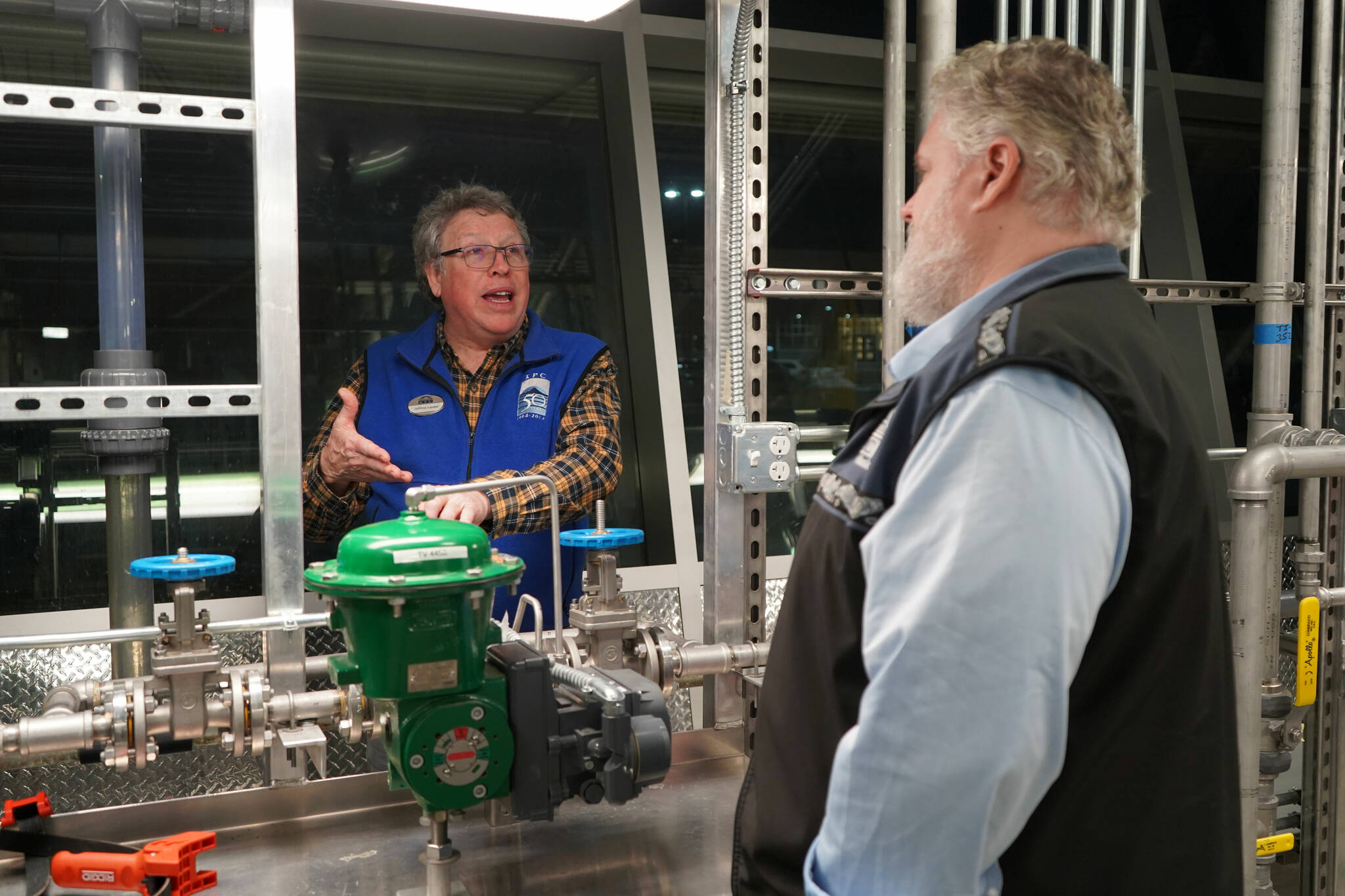 Professor of Process Technology Jeffrey Laube explains equipment to Kachemak Bay Campus Director Brian Partridge at a showcase of Kenai Peninsula College’s career and technical education programs in the college’s Career and Technical Center in Soldotna, Alaska, on Thursday, Feb. 20, 2025. (Jake Dye/Peninsula Clarion)