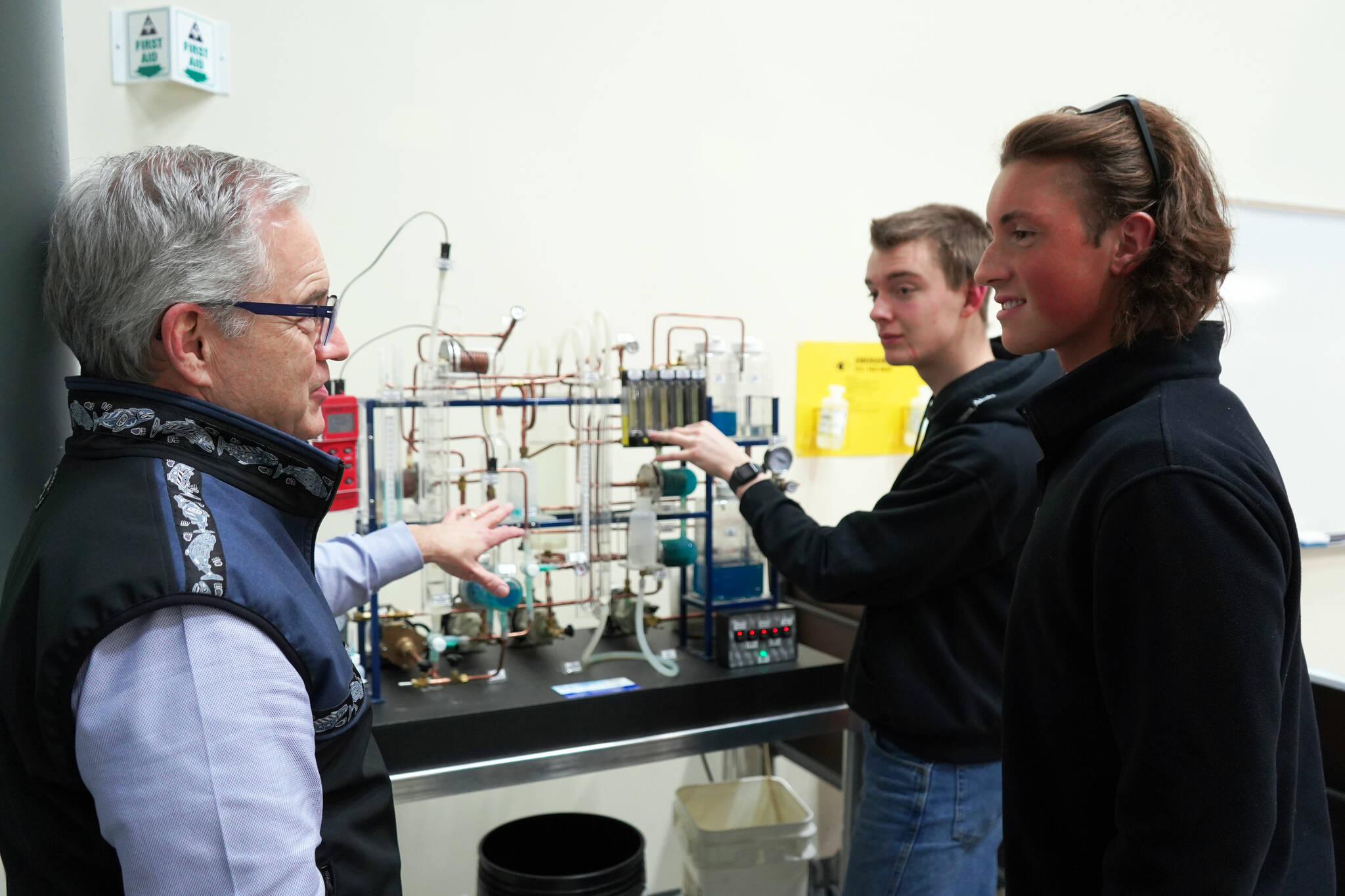 University of Alaska Anchorage Chancellor Sean Parnell asks Bryce Hopkins about a distillation model at a showcase of Kenai Peninsula College’s career and technical education programs in the college’s Career and Technical Center in Soldotna, Alaska, on Thursday, Feb. 20, 2025. (Jake Dye/Peninsula Clarion)