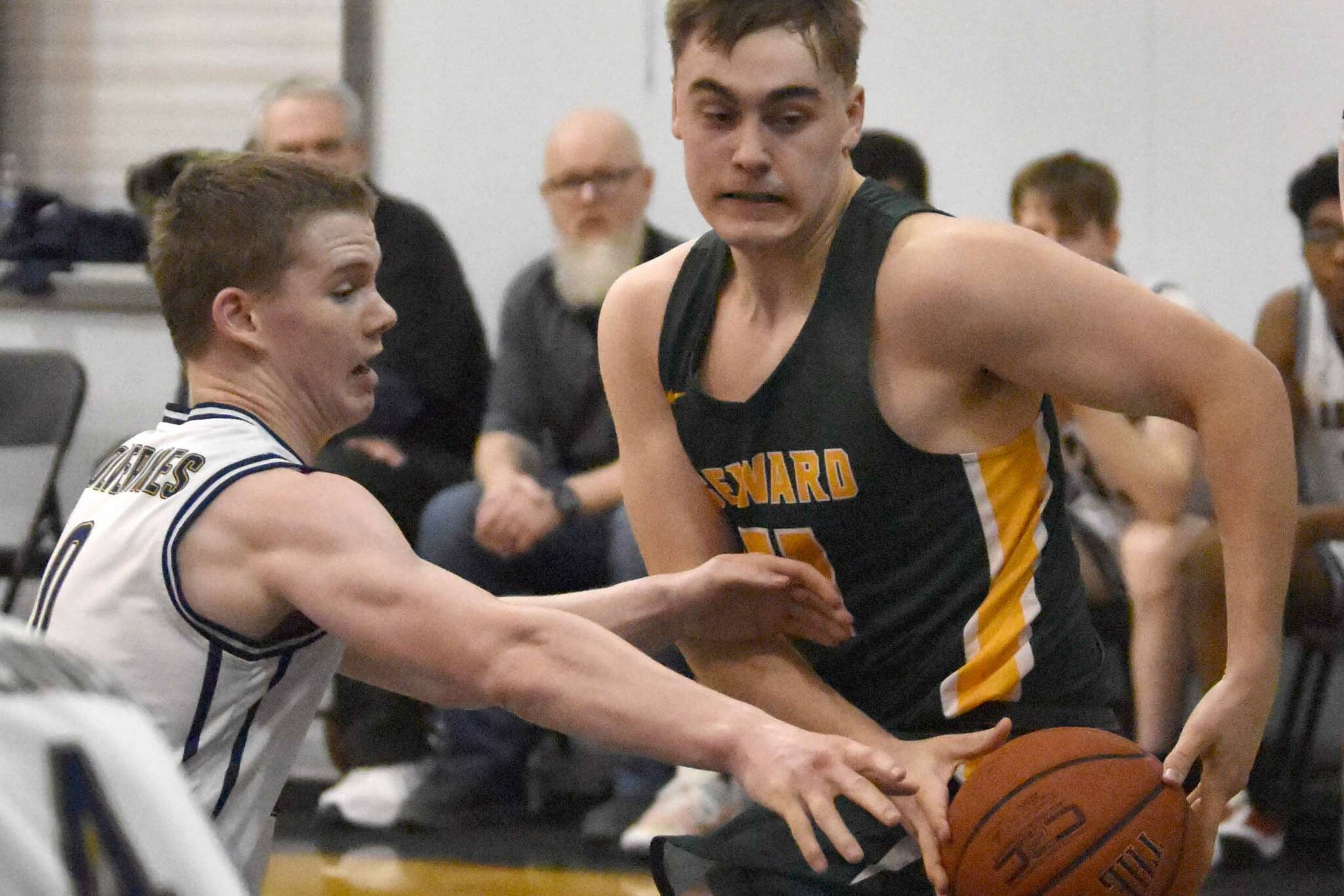 Ninilchik's Brandt Mill tries to steal the ball from Seward's Talon Lemme on Friday, February 21, 2025, at Ninilchik School in Ninilchik, Alaska. (Photo by Jeff Helminiak/Peninsula Clarion)
