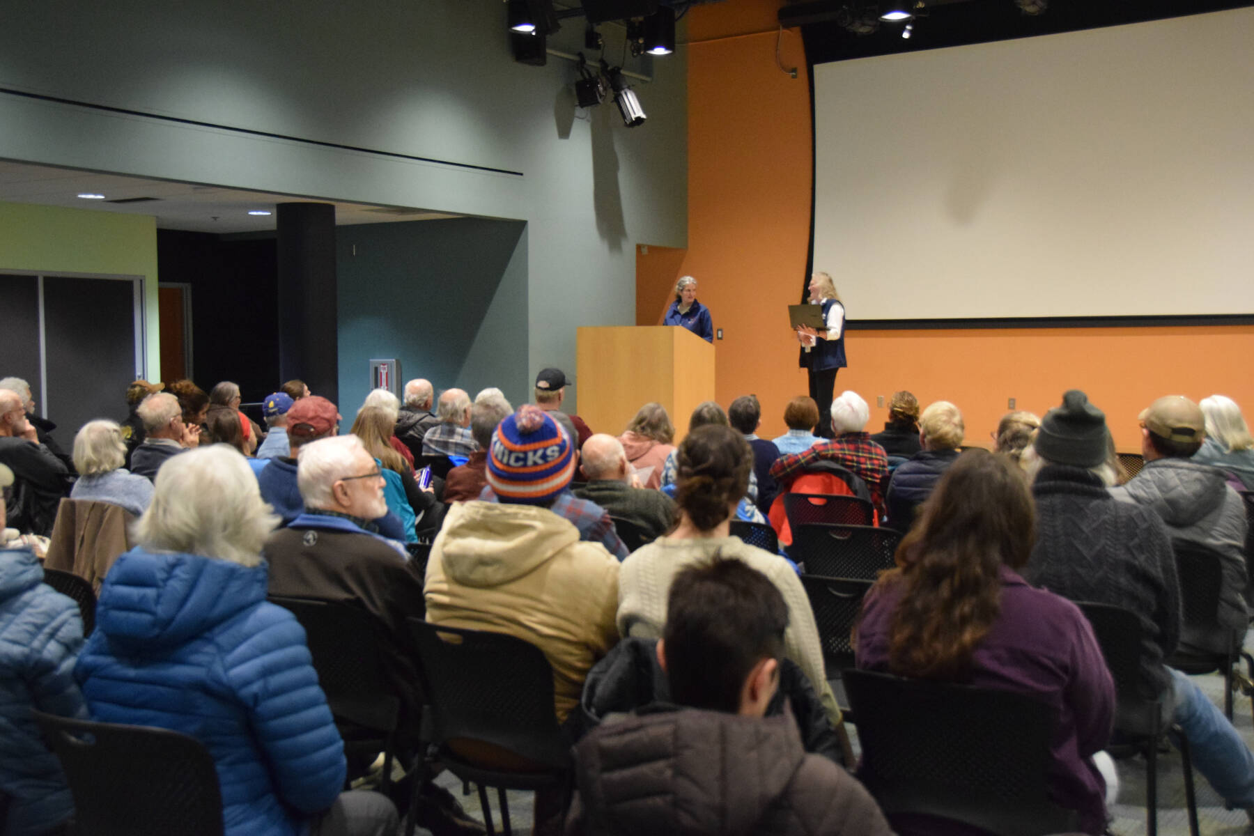Biologist Heather Renner and Friends of Alaska National Wildlife Refuges board member Poppy Benson facilitate questions from the crowd on Feb. 18, 2025, at the Alaska Maritime National Wildlife Refuge in Homer, Alaska. (Chloe Pleznac/Homer News)