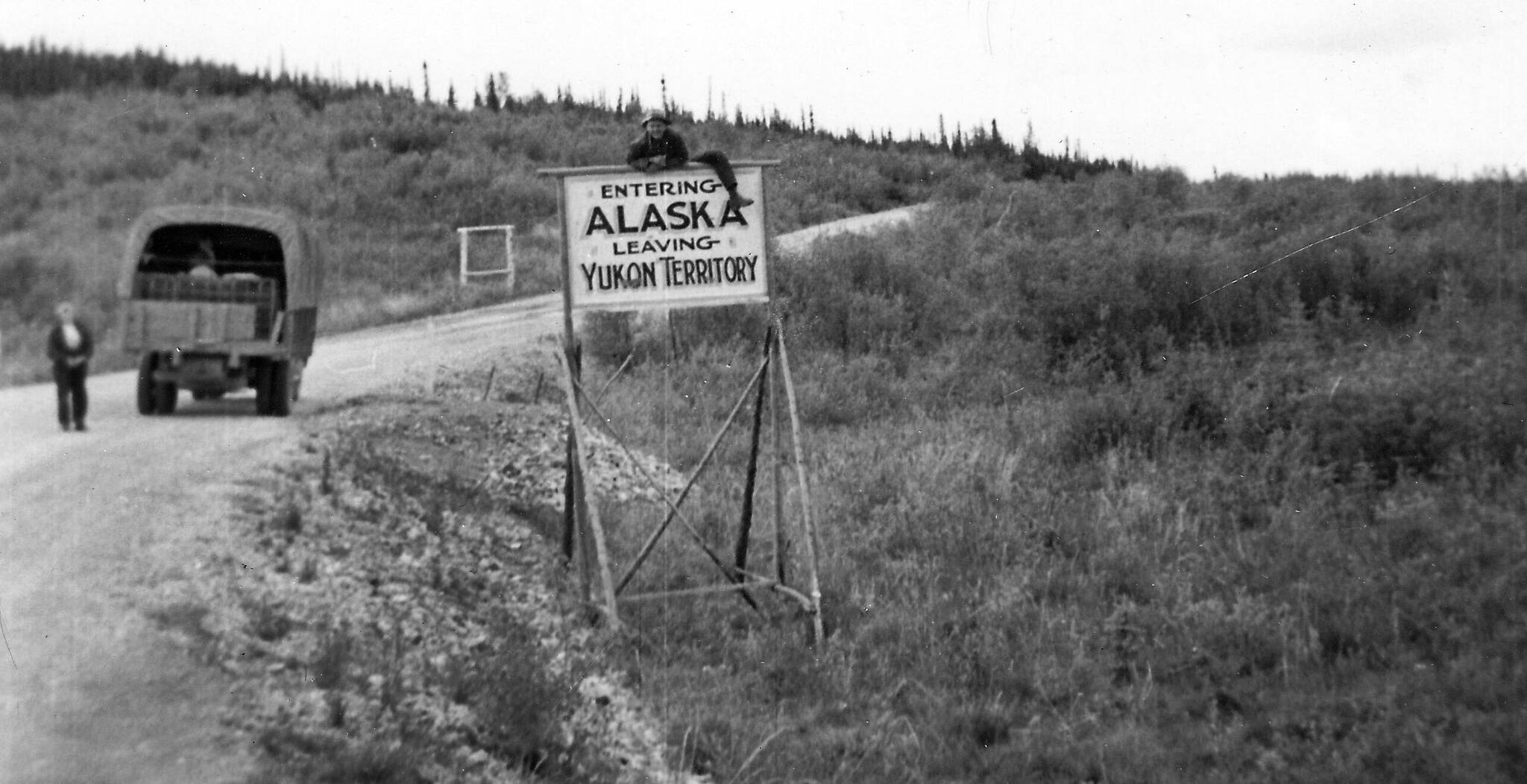 As his wife Bernice looks on, 43-year-old Clarence Hiram “Poopdeck” Platt poses atop a road sign welcoming him to Alaska. This 1947 photograph from the Huebsch Family Collection memorializes Platt’s first trip to Alaska, which became his home for the next 53 years.