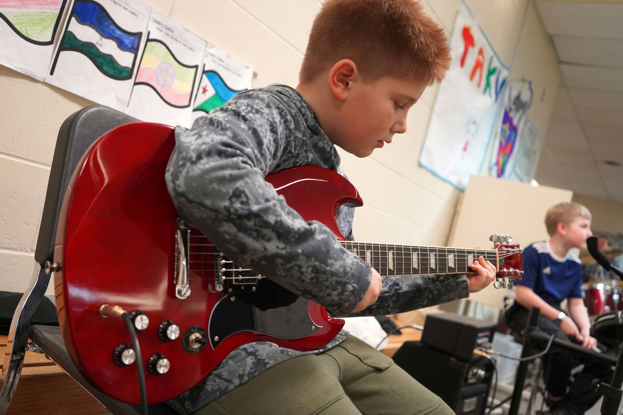 Soldotna Elementary School students perform in the halls during an art show and music fundraiser at Soldotna Elementary School in Soldotna, Alaska, on Thursday, Feb. 27, 2025. (Jake Dye/Peninsula Clarion)