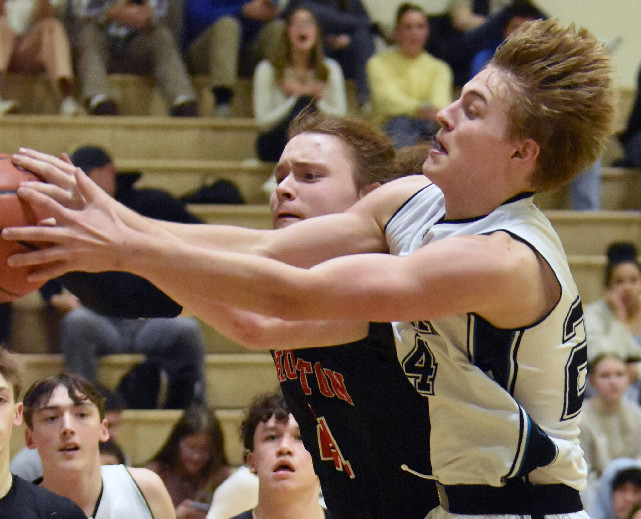 Nikiski’s Ethan Ellis and Houston’s Ethan Slaton battle for the ball Friday, February 28, 2025, at Nikiski Middle-High School in Nikiski, Alaska. (Photo by Jeff Helminiak/Peninsula Clarion)