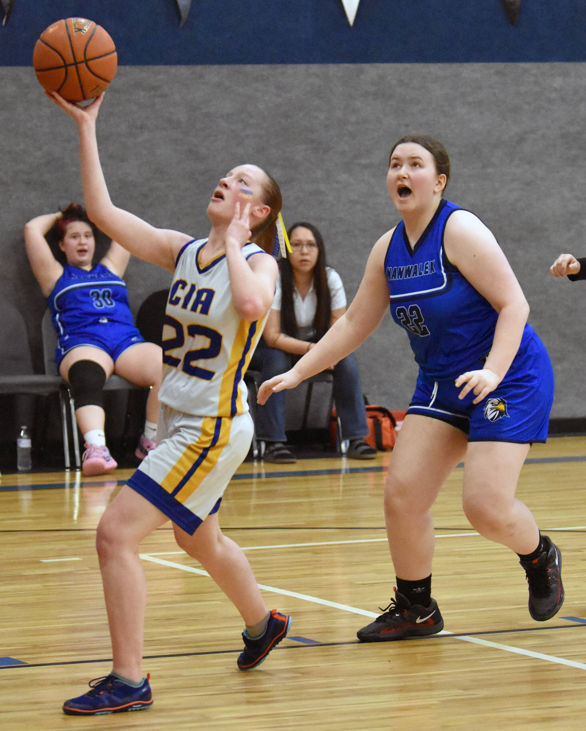 Cook Inlet Academy’s Beka Dillingham drives on Nanwalek’s Hadassah Haskins on Saturday, March 1, 2025, at the Peninsula Conference tournament at Cook Inlet Academy just outside of Soldotna, Alaska. (Photo by Jeff Helminiak/Peninsula Clarion)