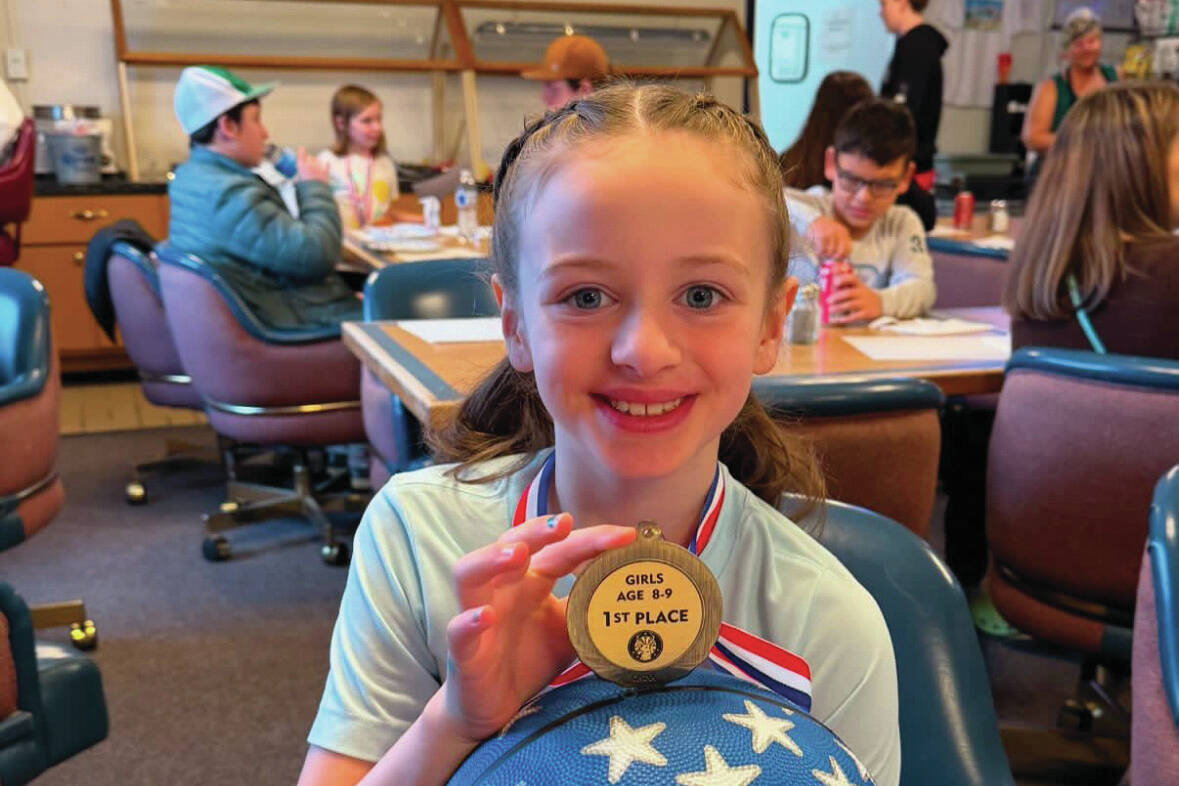 Laila Taylor sits with her 1st place medal from the Kenai Elks Lodge Hoop Shoot at the Kenai Elks Lodge in Kenai, Alaska, on Saturday, Nov. 16, 2024. (Photo provided by Amber Rouswell)