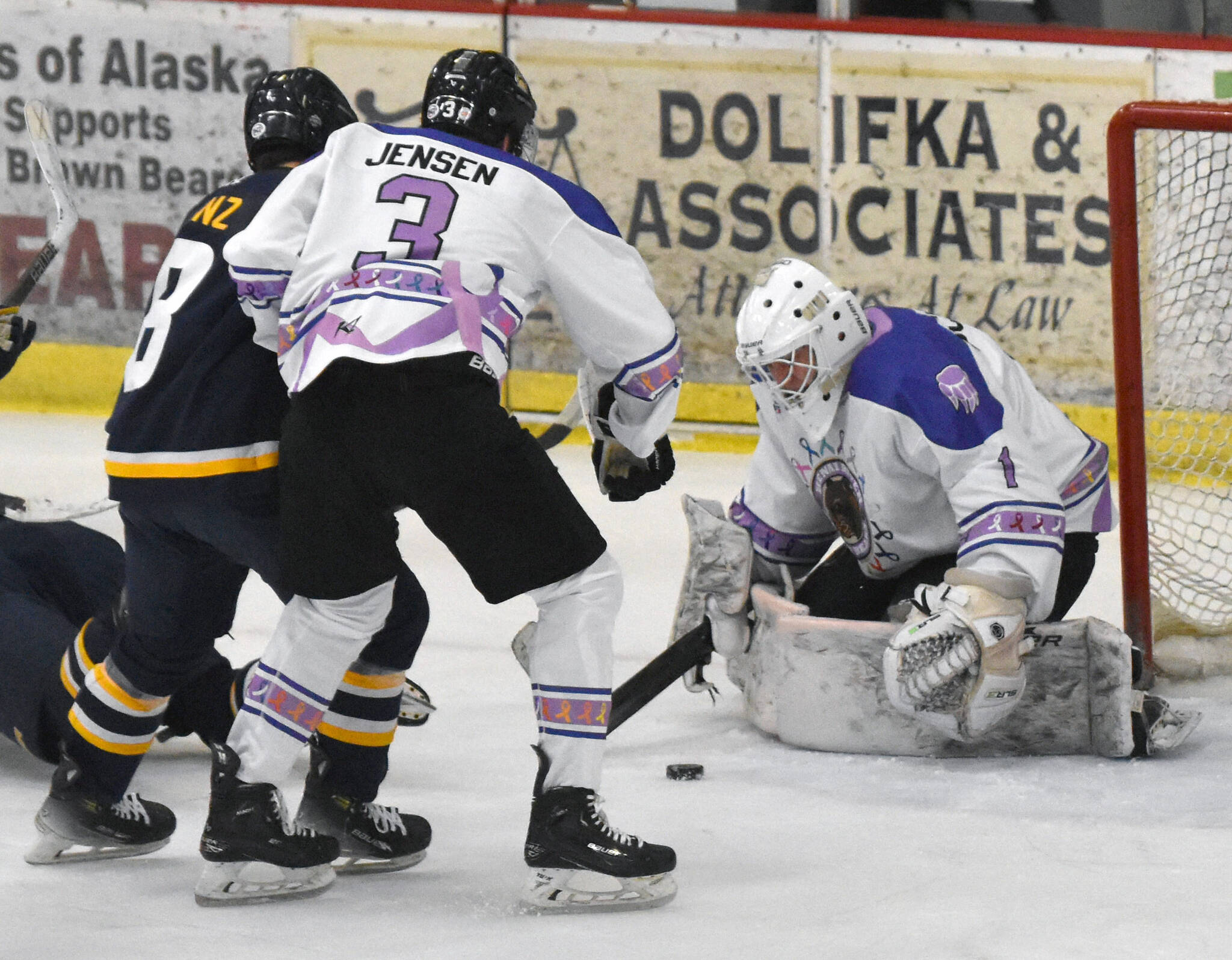 Kenai River Brown Bears goaltender Mitchell Mccusker makes a save in front of Logan Ganz of the Springfield (Illinois) Jr. Blues and Gavin Jensen of the Bears on Thursday, March 6, 2025, at the Soldotna Regional Sports Complex in Soldotna, Alaska. (Photo by Jeff Helminiak/Peninsula Clarion)