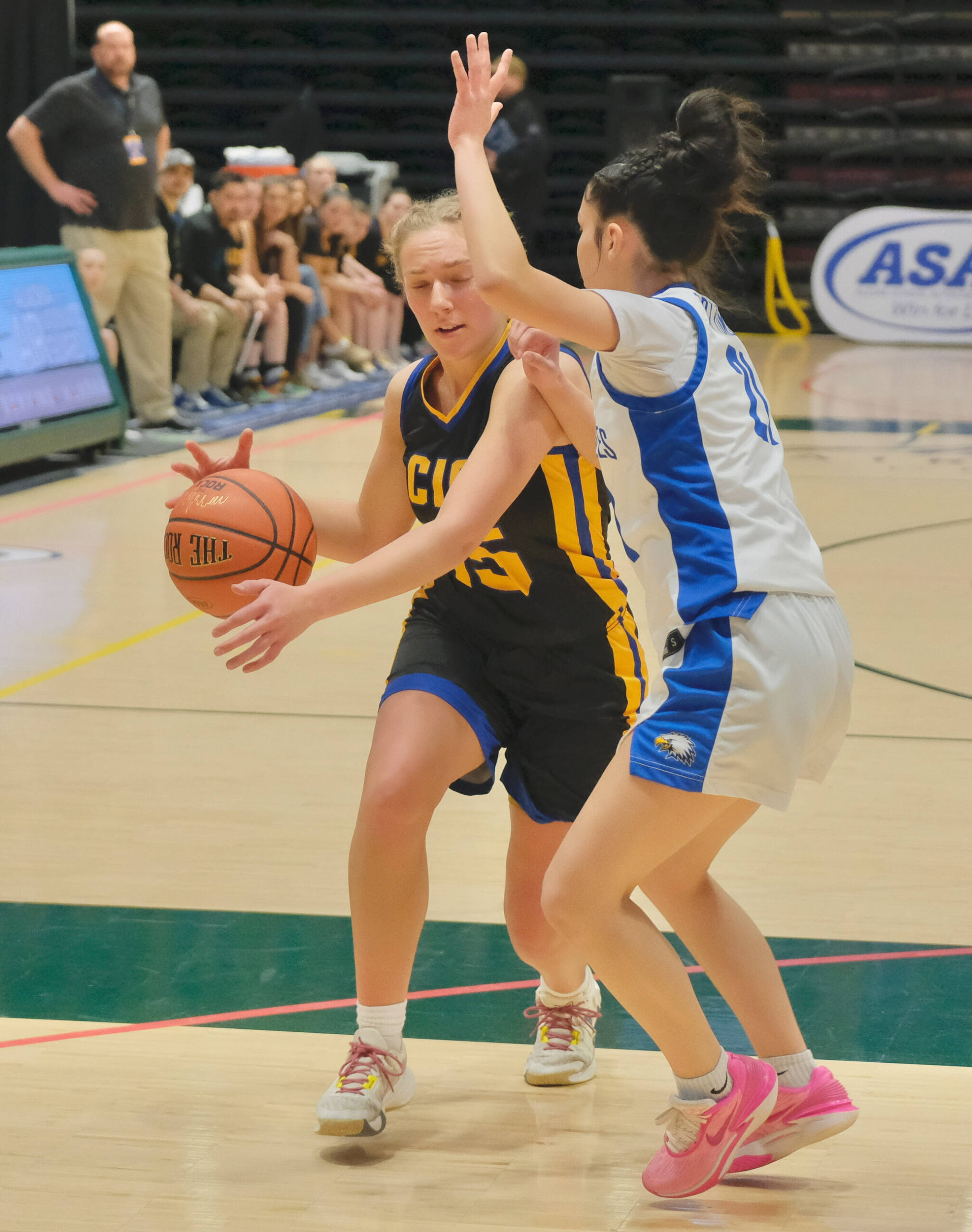 Cook Inlet Academy junior Clara Warren drives against Fort Yukon sophomore Karli Thomas during their opening game at the 2025 ASAA March Madness Alaska 1A/2A State Basketball Championships on Wednesday, March 12, 2025, at the Alaska Airlines Center in Anchorage, Alaska. (Klas Stolpe / Juneau Empire)