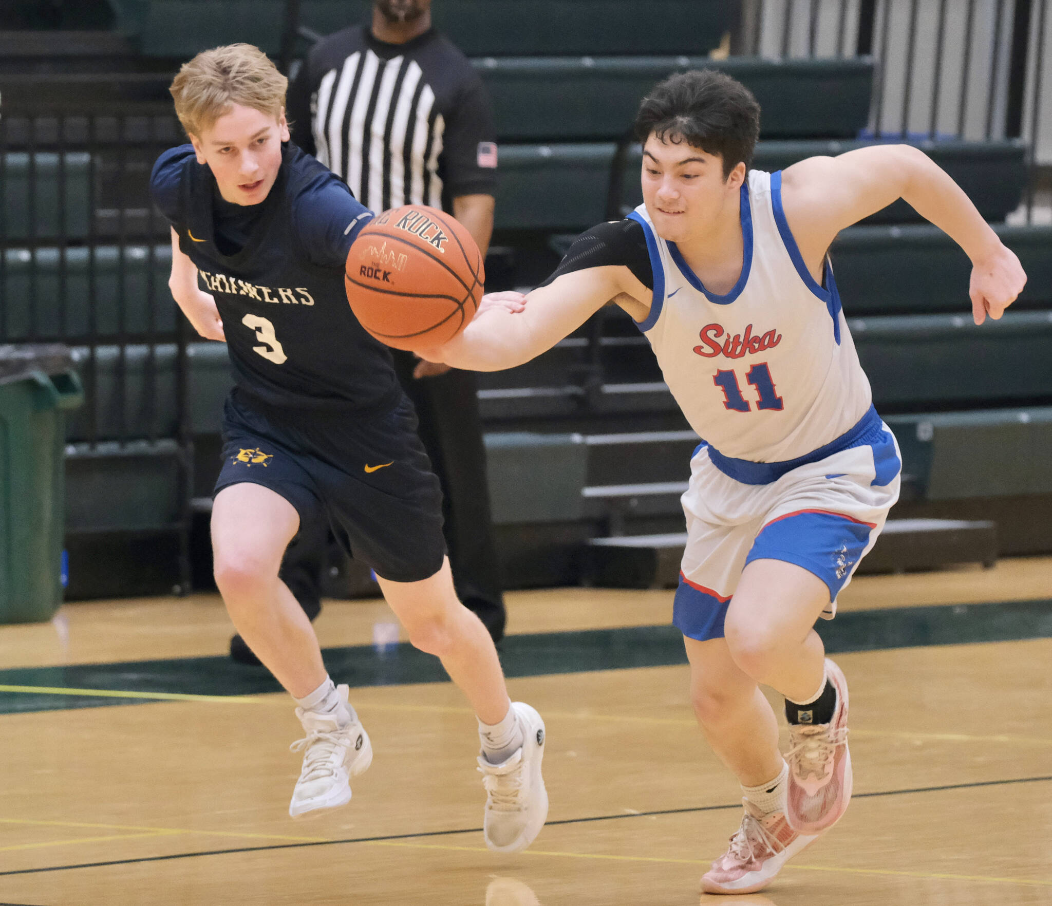Sitka junior Kai Hirai (11) steals a ball from Homer senior Spencer Dye (3) during the Wolves’ 61-24 win over the Mariners on Wednesday, March 19, 2025, at the 2025 ASAA March Madness Alaska 3A/4A Basketball State Championships at the Alaska Airlines Center in Anchorage, Alaska. (Klas Stolpe / Juneau Empire)
