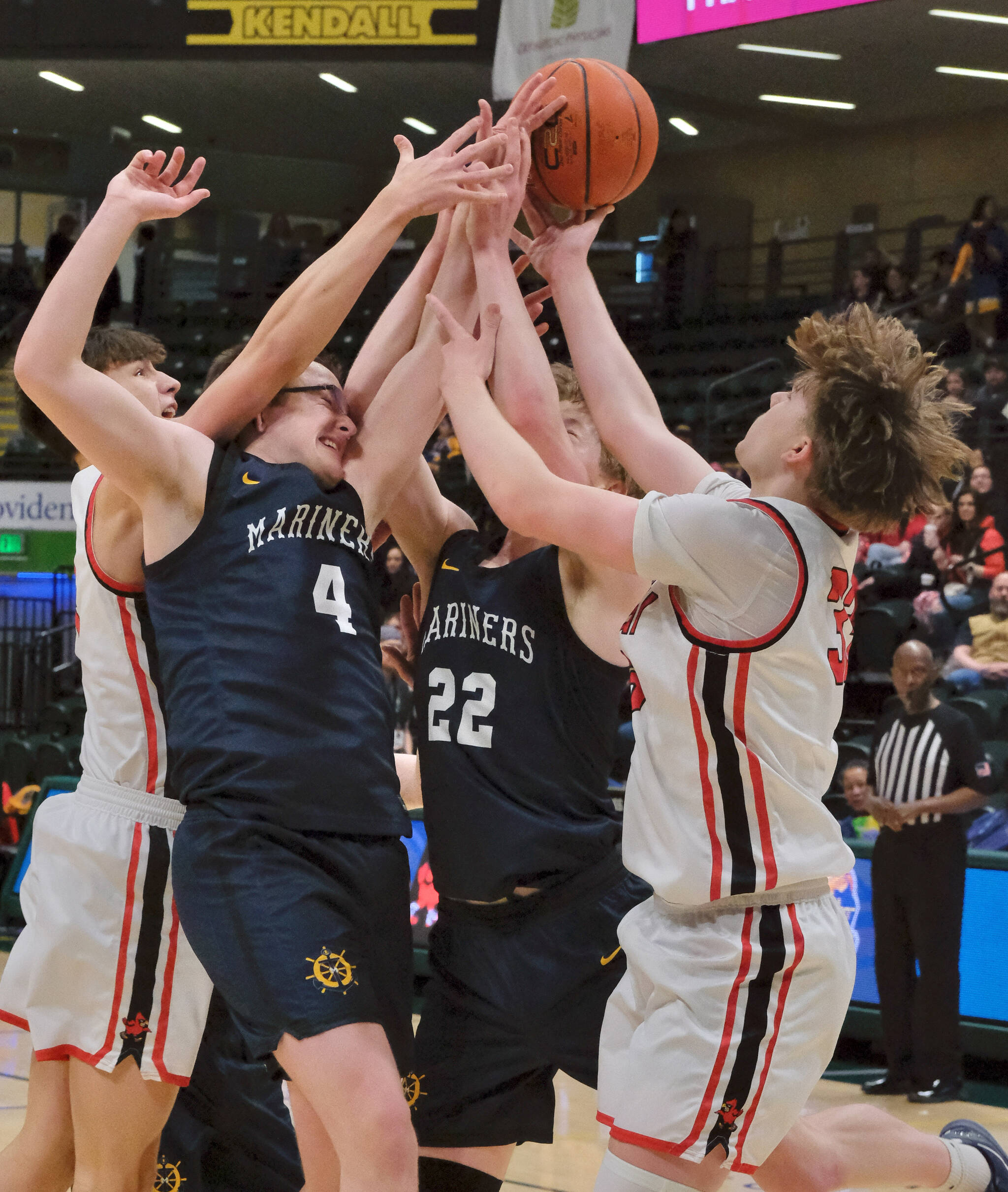 Kenai’s Miles Metteer, Homer’s Einar Pederson (4) and Henry Wedvik (22) and Kenai’s Mason Tunseth (33) battle for a rebound on Thursday, March 20, 2025, in their consolation bracket semifinal during the 2025 ASAA March Madness Alaska 3A/4A Basketball State Championships at the Alaska Airlines Center in Anchorage, Alaska. (Klas Stolpe / Juneau Empire)