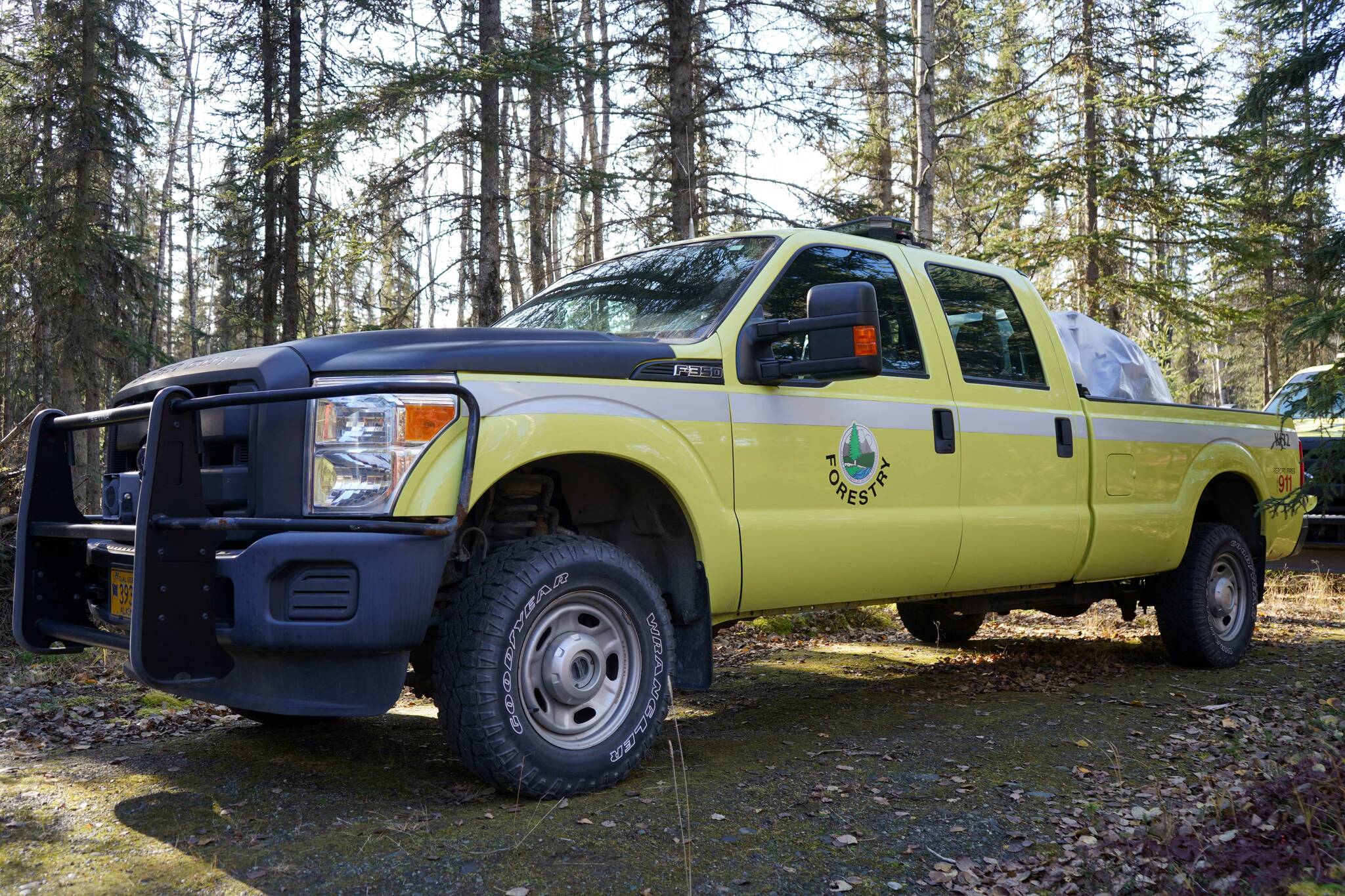 An Alaska Division of Forestry and Fire Protection vehicle stands among trees in Funny River, Alaska, on Oct. 2, 2024. (Jake Dye/Peninsula Clarion)