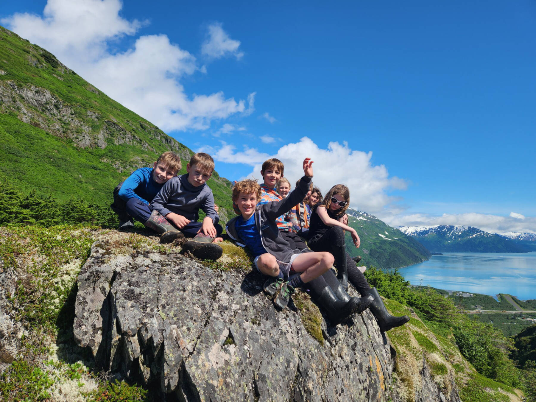 Students smile from atop a mountain peak while engaged in KMTA’s Pathfinders program. The program fosters environmental literacy and lifelong learning using an experiential, inquiry-based teaching model and helps expose students to the rich histories, environments and recreation opportunities available in the KMTA. (Photo courtesy of KMTA)