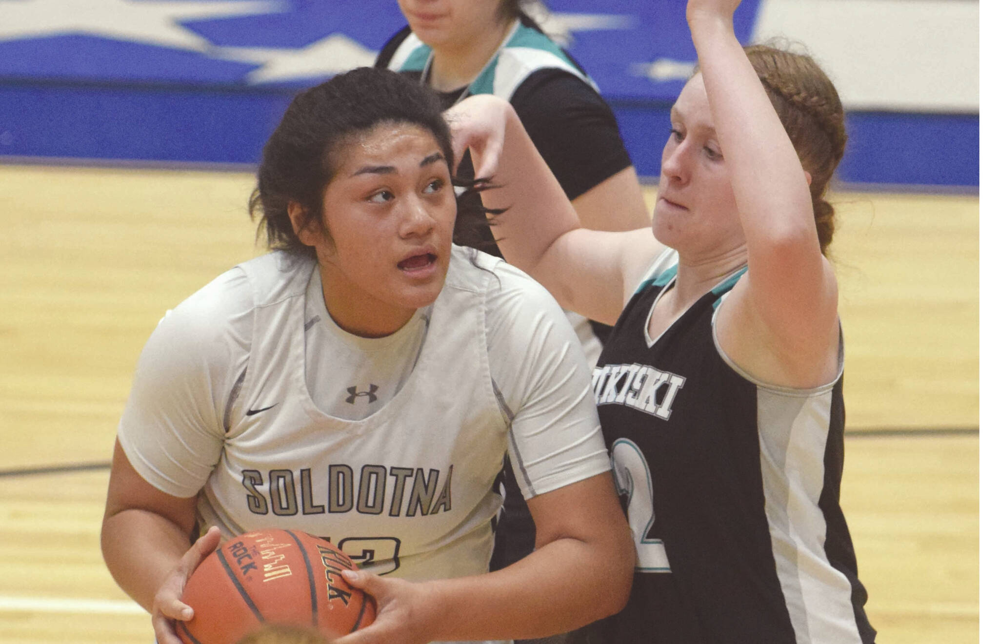 Soldotna's Ituau Tuisaula powers up against Nikiski's Kaycee Bostic on Tuesday, Jan. 21, 2020, at Soldotna High School in Soldotna, Alaska. (Photo by Jeff Helminiak/Peninsula Clarion)