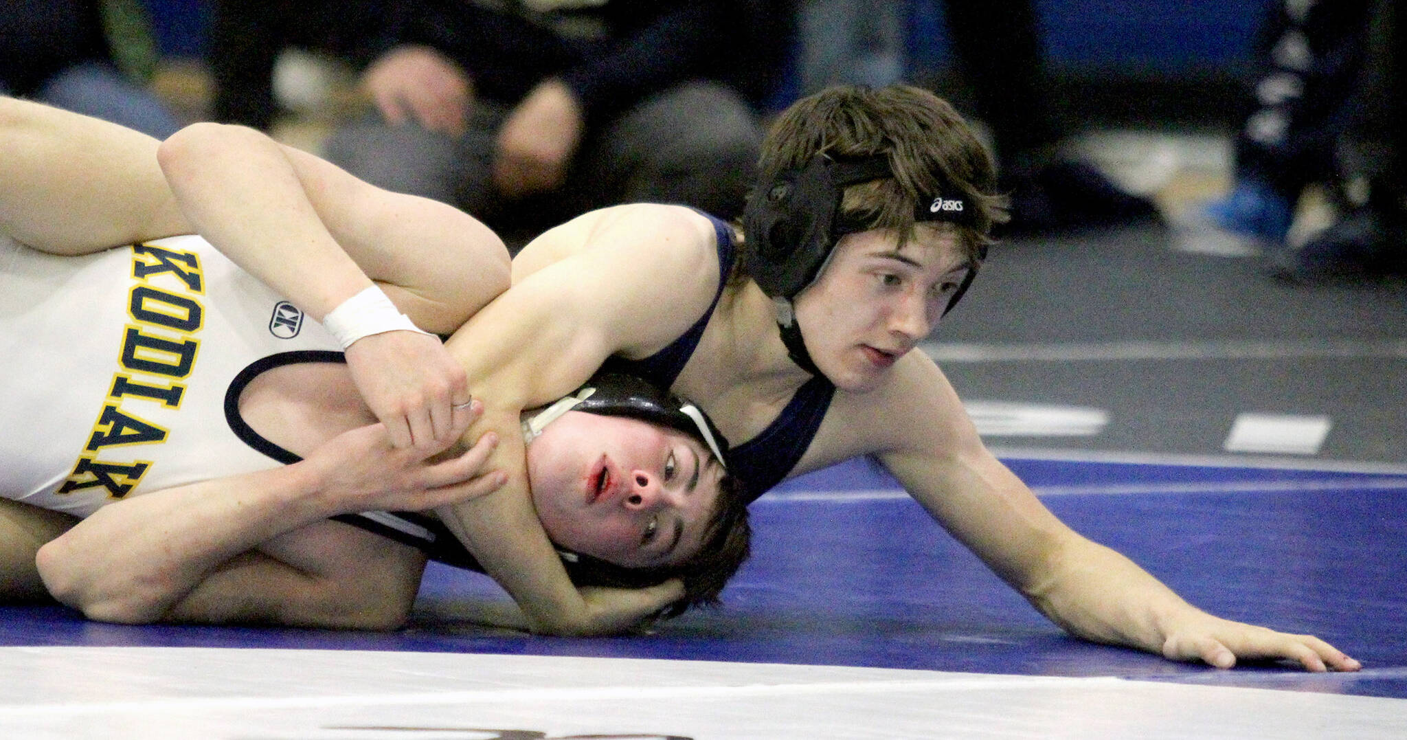 Soldotna’s Ryan Buchanan works to pin Kodiak’s Luke Lester during the boys 119-pound final of the Northern Lights Conference Championships Saturday, Dec. 14, 2024, at Palmer High School in Palmer, Alaska. (Photo by Jeremiah Bartz/Frontiersman)
