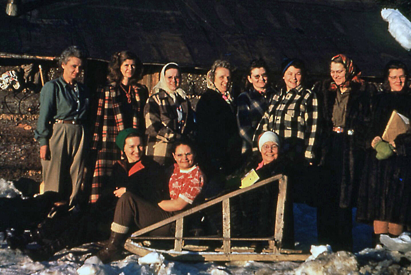 During her brief time on the southern Kenai Peninsula, Dorothy Miller, wife of Cecil “Greasy” Miller, was a part of the Anchor Point Homemakers Club. Here, Dorothy (far left, standing) joins fellow area homemakers for a 1950 group shot. Sitting on the sled, in the red blouse, is Dorothy’s daughter, Evelyn, known as “Evie.” (Photo courtesy of the Pratt Museum)