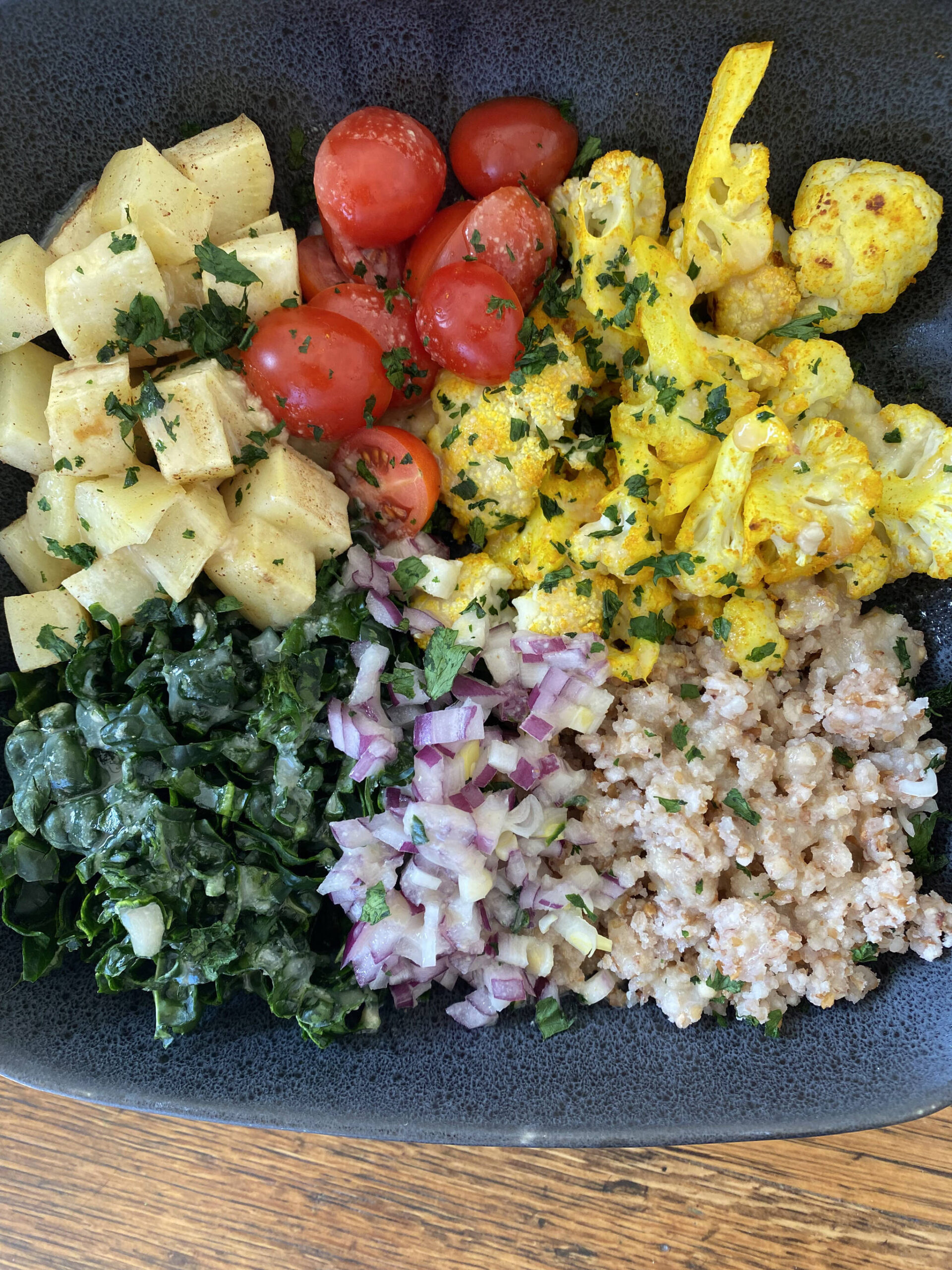 Sweet potatoes, tomatoes, cauliflower, kale, onions and buckwheat are served in this rich, healthy salad. (Photo by Tressa Dale/Peninsula Clarion)
