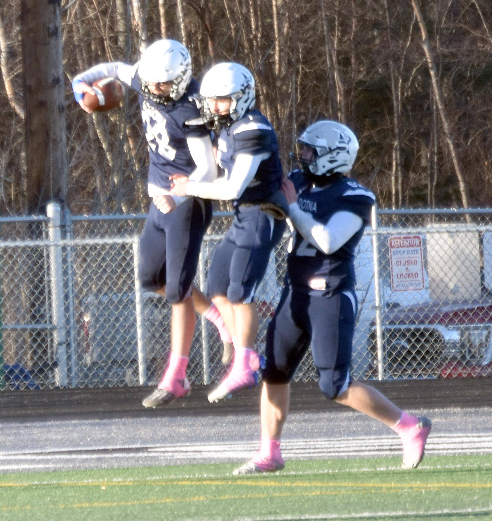 Soldotna’s Wyatt Faircloth celebrates his touchdown with Owen Buckbee and Dalton Armstrong on Saturday, Oct. 26, 2024, at the First National Bowl Division II title game at Pride Field at Colony High School in Palmer, Alaska. (Photo by Jeff Helminiak/Peninsula Clarion)