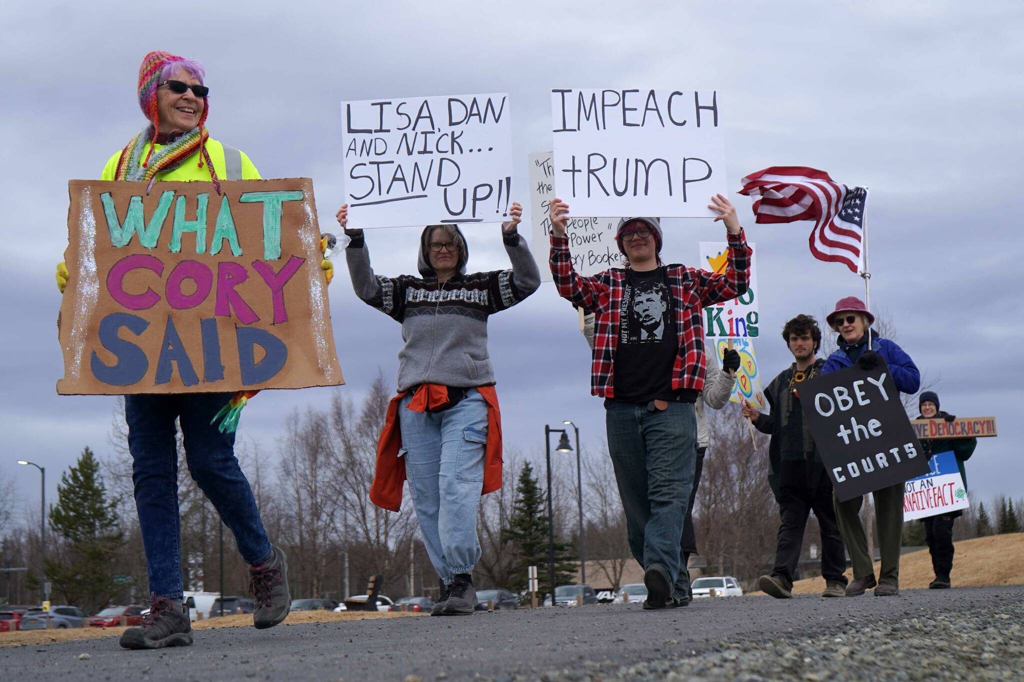 Protesters walk through Soldotna Creek Park in Soldotna, Alaska, participating in the “Remove, Reverse, Reclaim” protest organized by Many Voices and Kenai Peninsula Protests as part of the nationwide 50501 effort on Saturday, April 5, 2025. (Jake Dye/Peninsula Clarion)