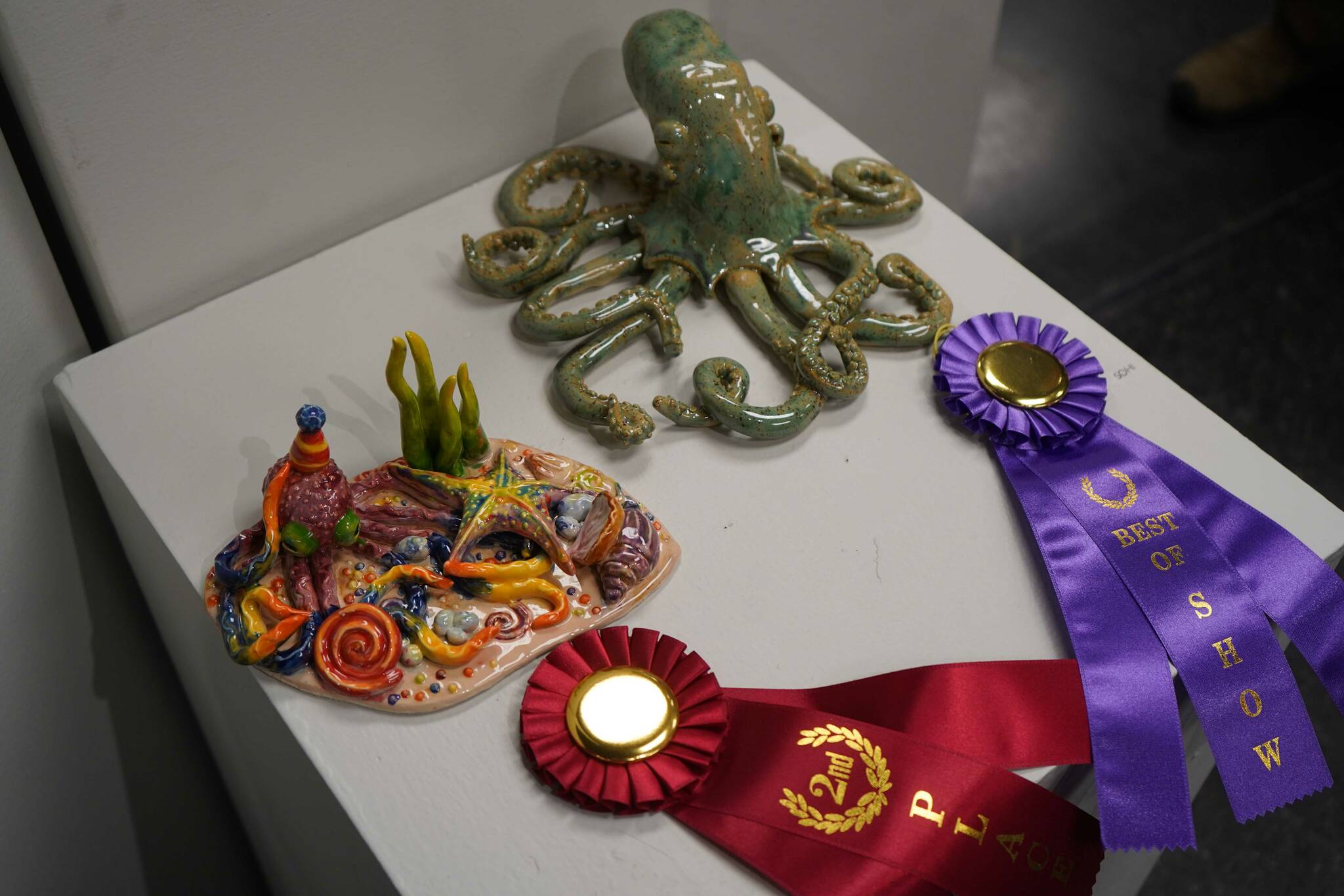“Octoparty,” by Kenai Alternative High School student Adelynn DeHoyos, and “Green Speckled Ocean,” by Soldotna High School Student Savannah Yeager are seen as part of the 34th Annual Visual Feast Kenai Peninsula Borough School District Juried Student Art Show during an opening reception at the Kenai Art Center in Kenai, Alaska, on Friday, April 4, 2025. (Jake Dye/Peninsula Clarion)