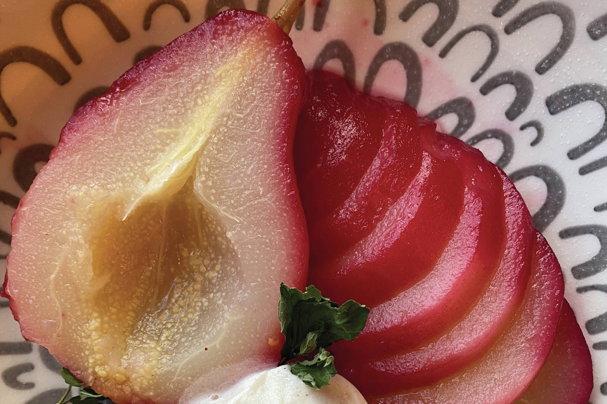 These poached pears get their red tinge from a cranberry juice bath. (Photo by Tressa Dale/Peninsula Clarion)
