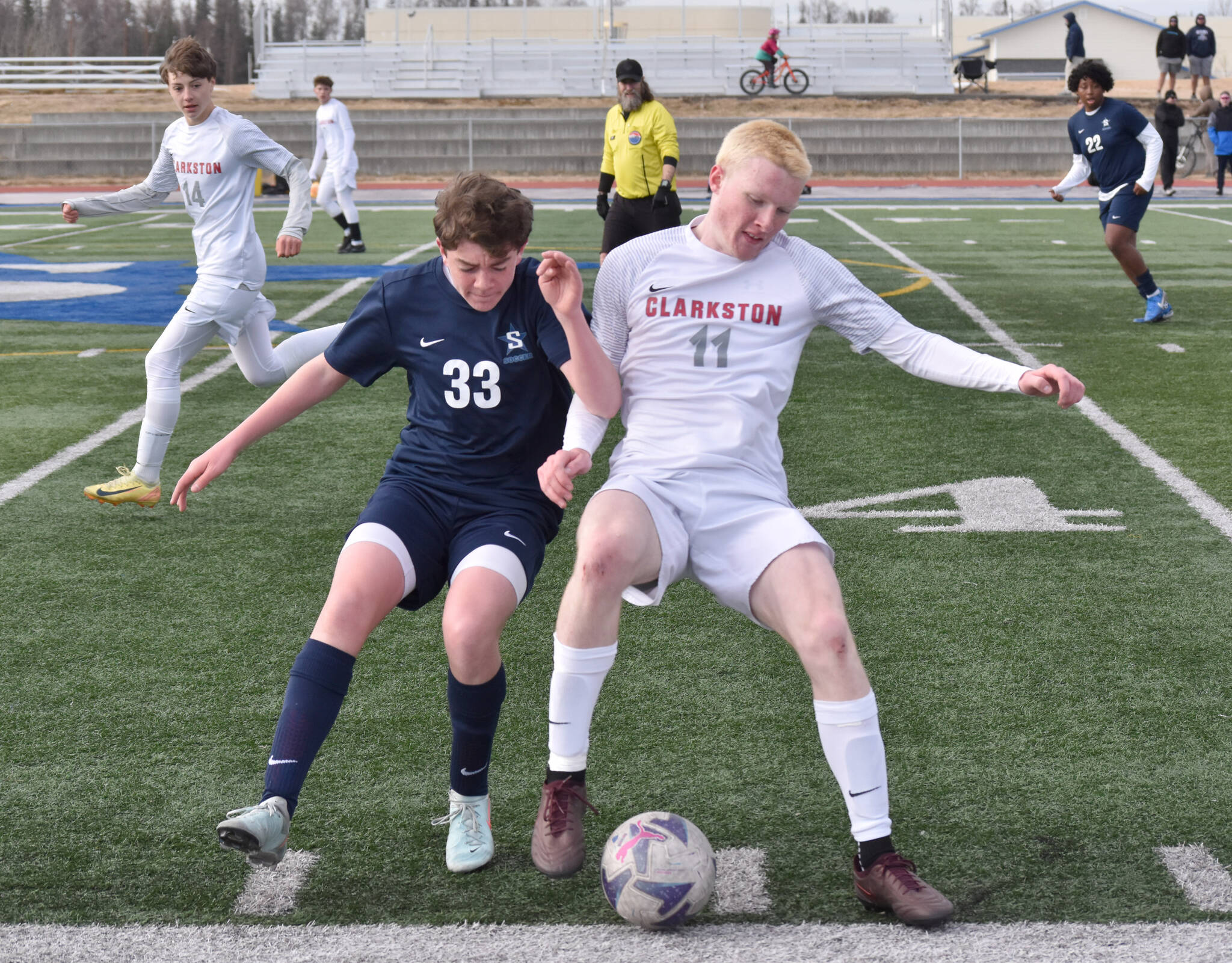 Soldotna’s Brody Linton and Quinlyn Snyder of Clarkston (Washington) battle for the ball at Justin Maile Field at Soldotna High School on Wednesday, April 9, 2025. (Photo by Jeff Helminiak/Peninsula Clarion)