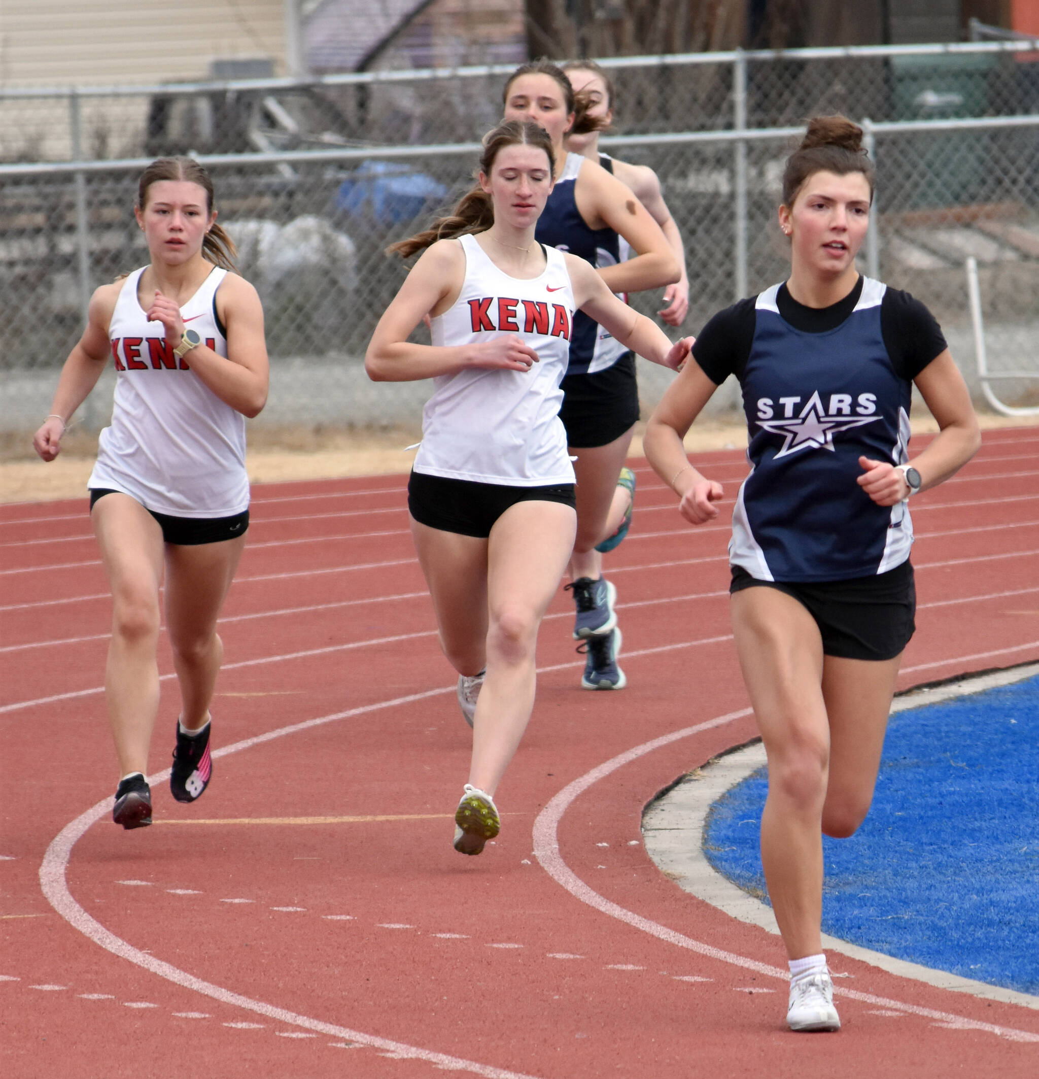 Soldotna’s Annie Burns leads Kenai Central’s Ruby Davis and Mya Taylor in the 800-meter run at the Soldotna Mini Meet on Tuesday, April 15, 2025, at Soldotna High School in Soldotna, Alaska. (Photo by Jeff Helminiak/Peninsula Clarion)