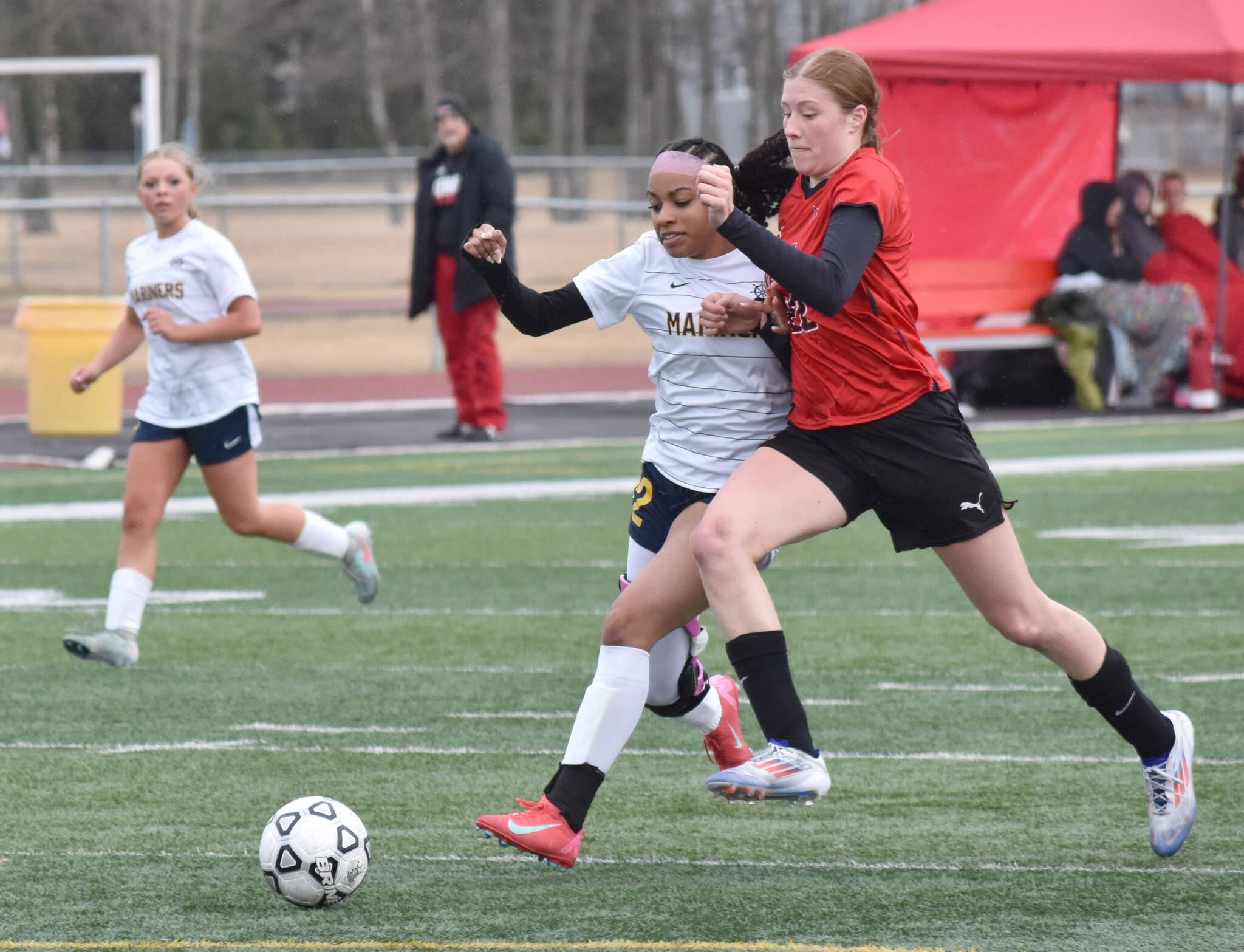 Homer’s Julianne Techie and Kenai Central’s Christine Goering battle for the ball Thursday, April 17, 2025, at Ed Hollier Field at Kenai Central High School in Kenai, Alaska. (Photo by Jeff Helminiak/Peninsula Clarion)