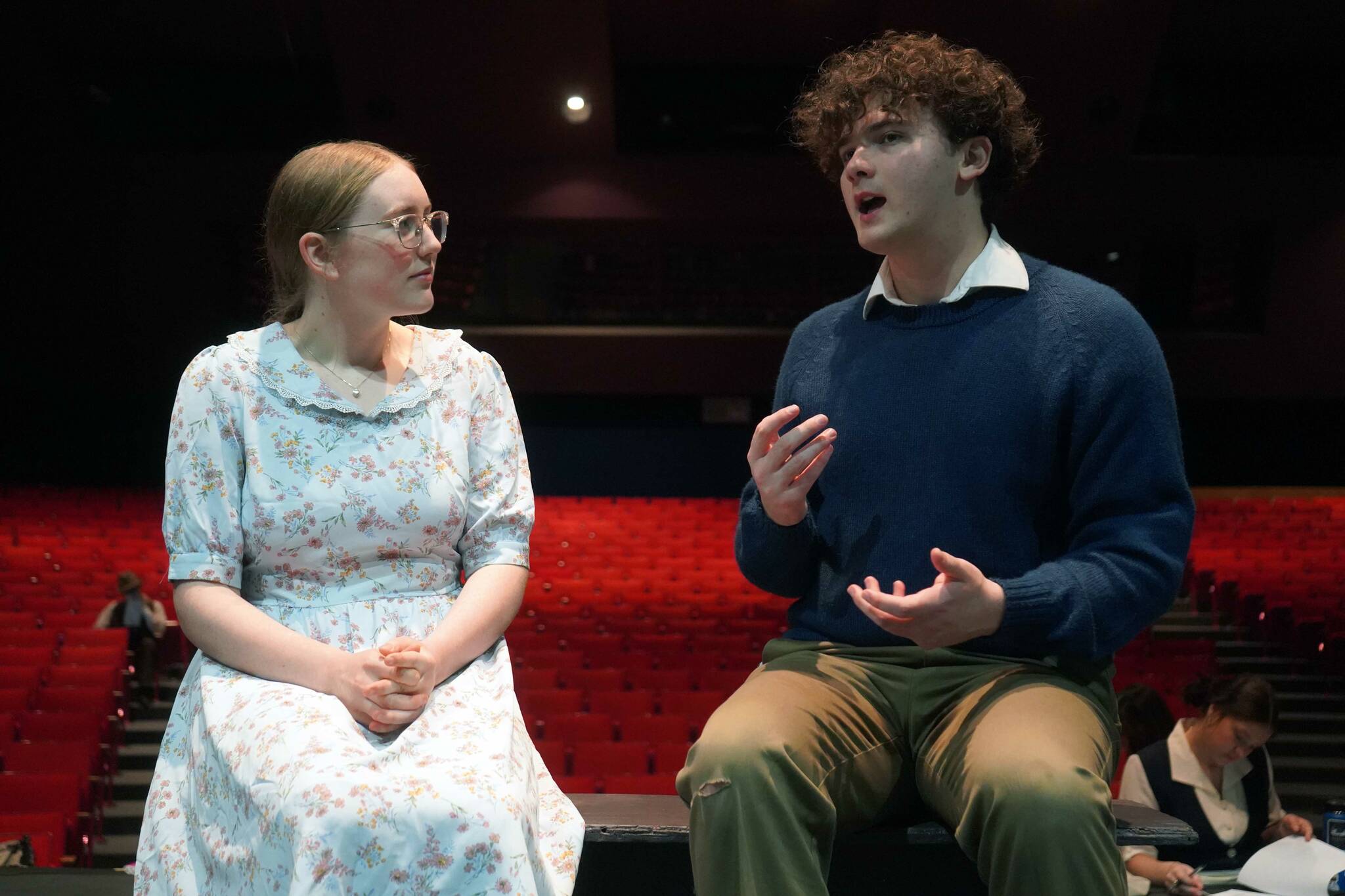 Emerson Kapp and Elias Bouschor rehearse “Our Town” in the Soldotna High School Auditorium in Soldotna, Alaska, on Friday, April 18, 2025. (Jake Dye/Peninsula Clarion)